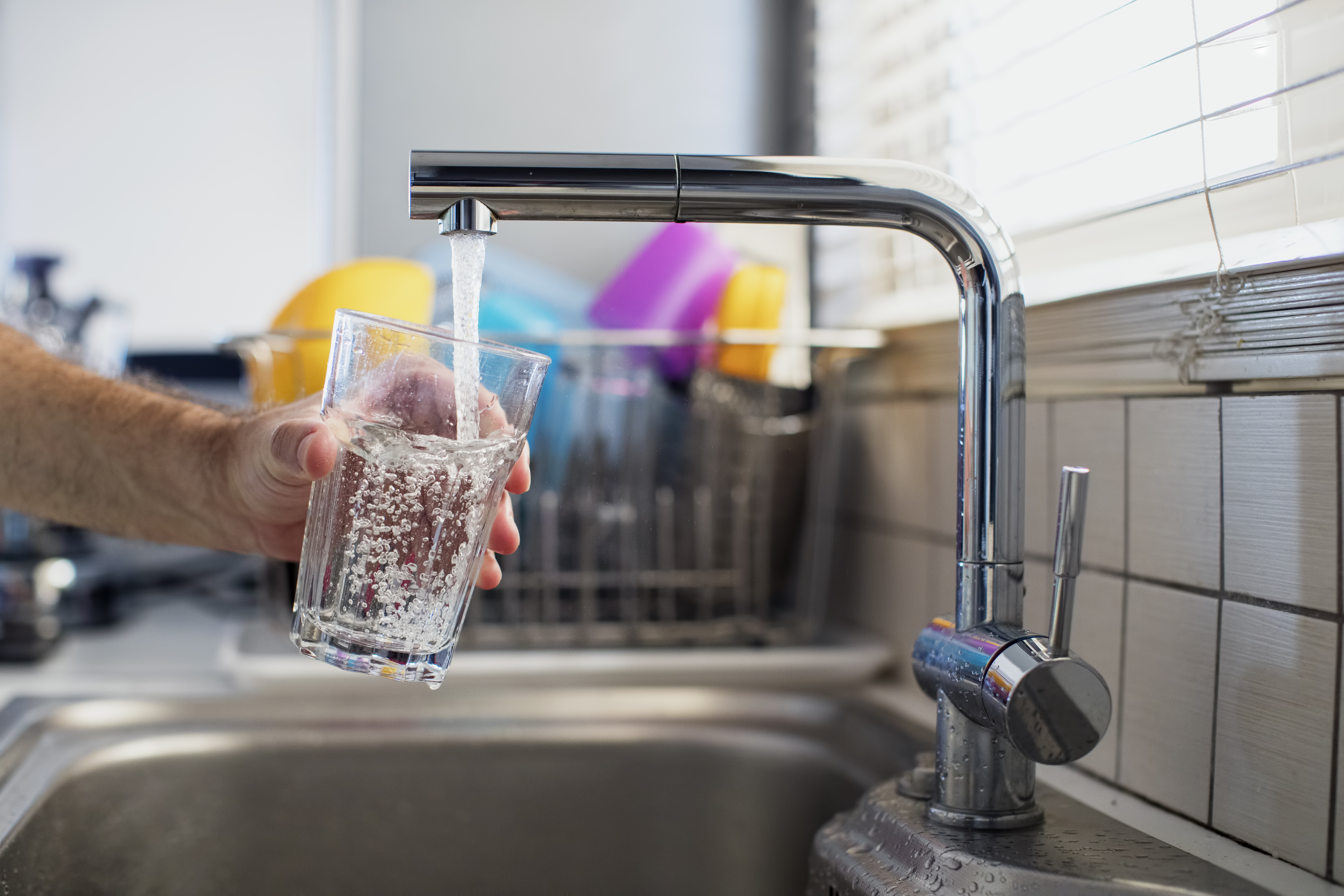 A man holding a glass of water is seen in this file photo. (Credit: Thanasis Zovoilis via Getty Images)