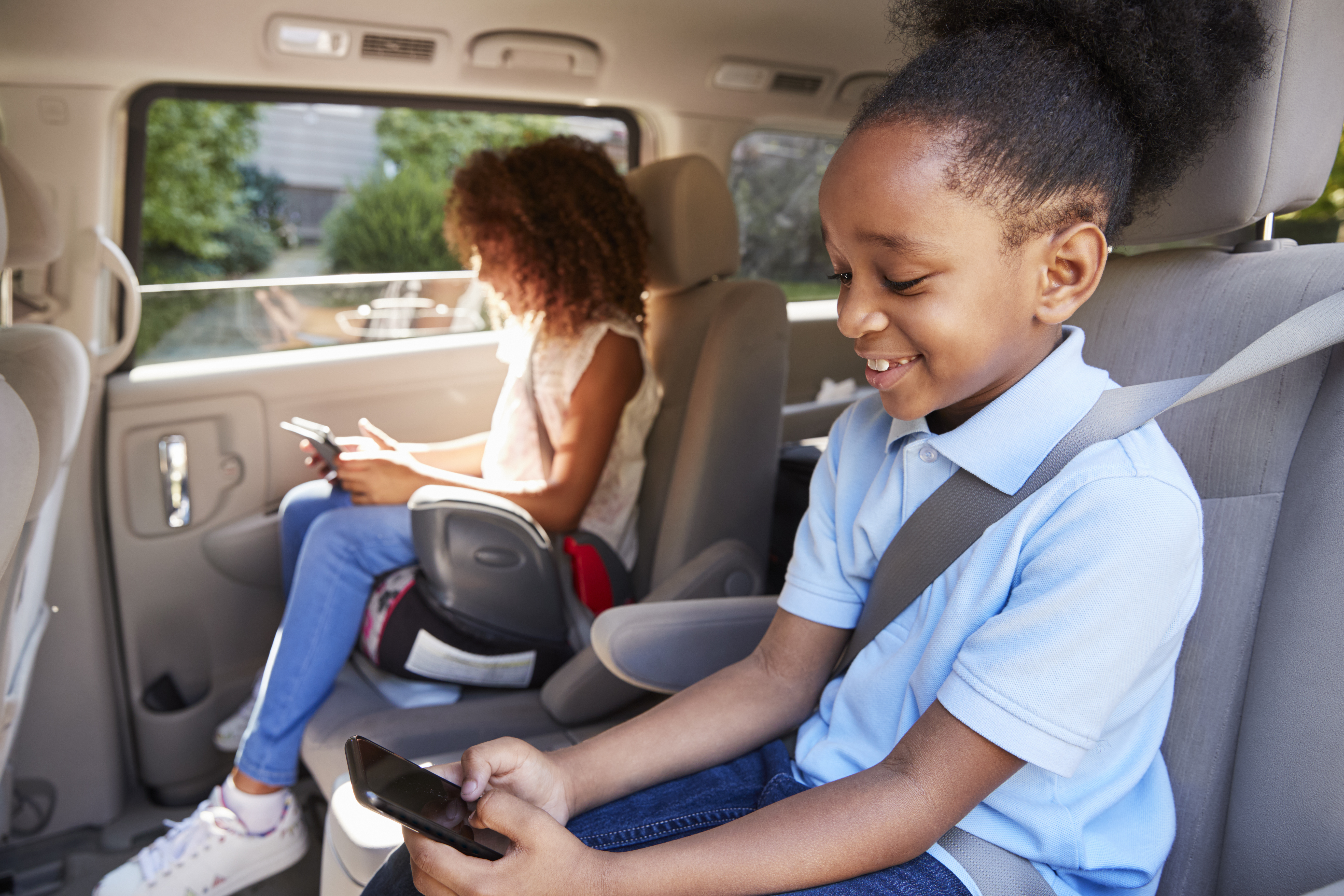 Children are seen in a booster seat in this file photo. (Credit: iStock / Getty Images Plus)