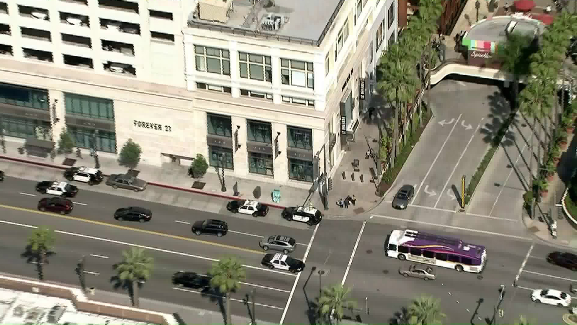 Police respond to the Americana at Brand mall in Glendale after a man jumped from a roof there and landed on another man on April 2, 2019. (Credit: KTLA)