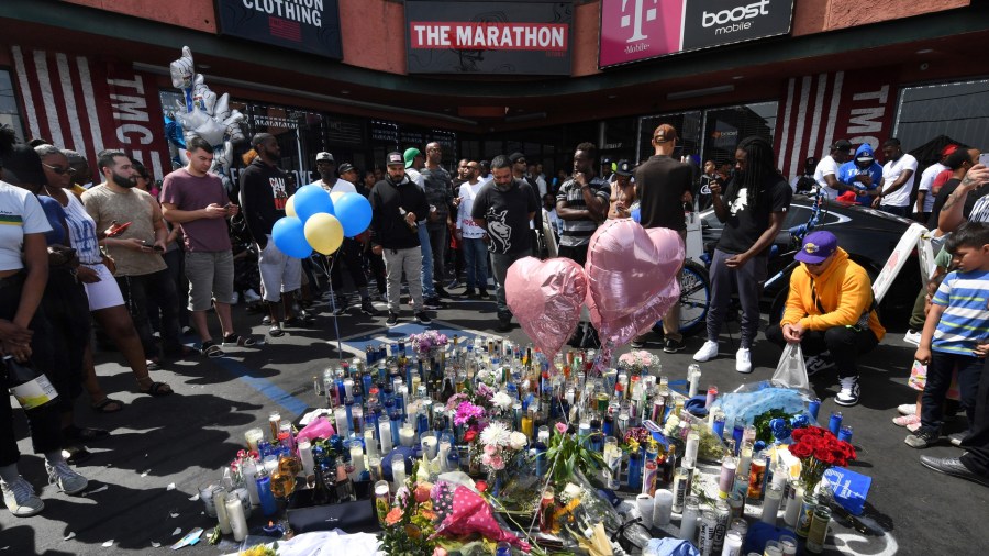 Fans pay their respects at a makeshift memorial outside The Marathon clothing store owned by Grammy-nominated rapper Nipsey Hussle where he was fatally shot along with 2 other wounded in Los Angeles.(Credit: MARK RALSTON/AFP/Getty Images)