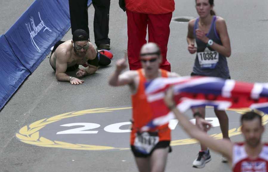 Micah Herndon crawls to the finish line in the 123rd Boston Marathon. He crossed the line at three hours and 38 minutes. (Credit: Charles Krupa/AP)