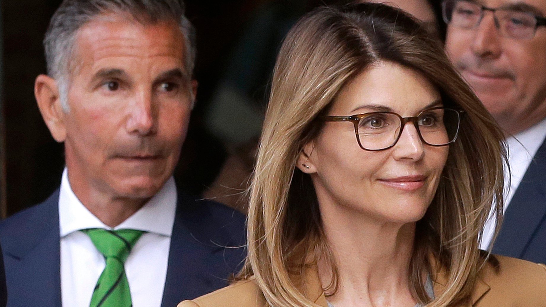 Fashion designer Mossimo Giannulli, left, leaves a federal courthouse in Boston behind his wife, actress Lori Loughlin, on April 3, 2019. (Pat Greenhouse / The Boston Globe via Getty Images)