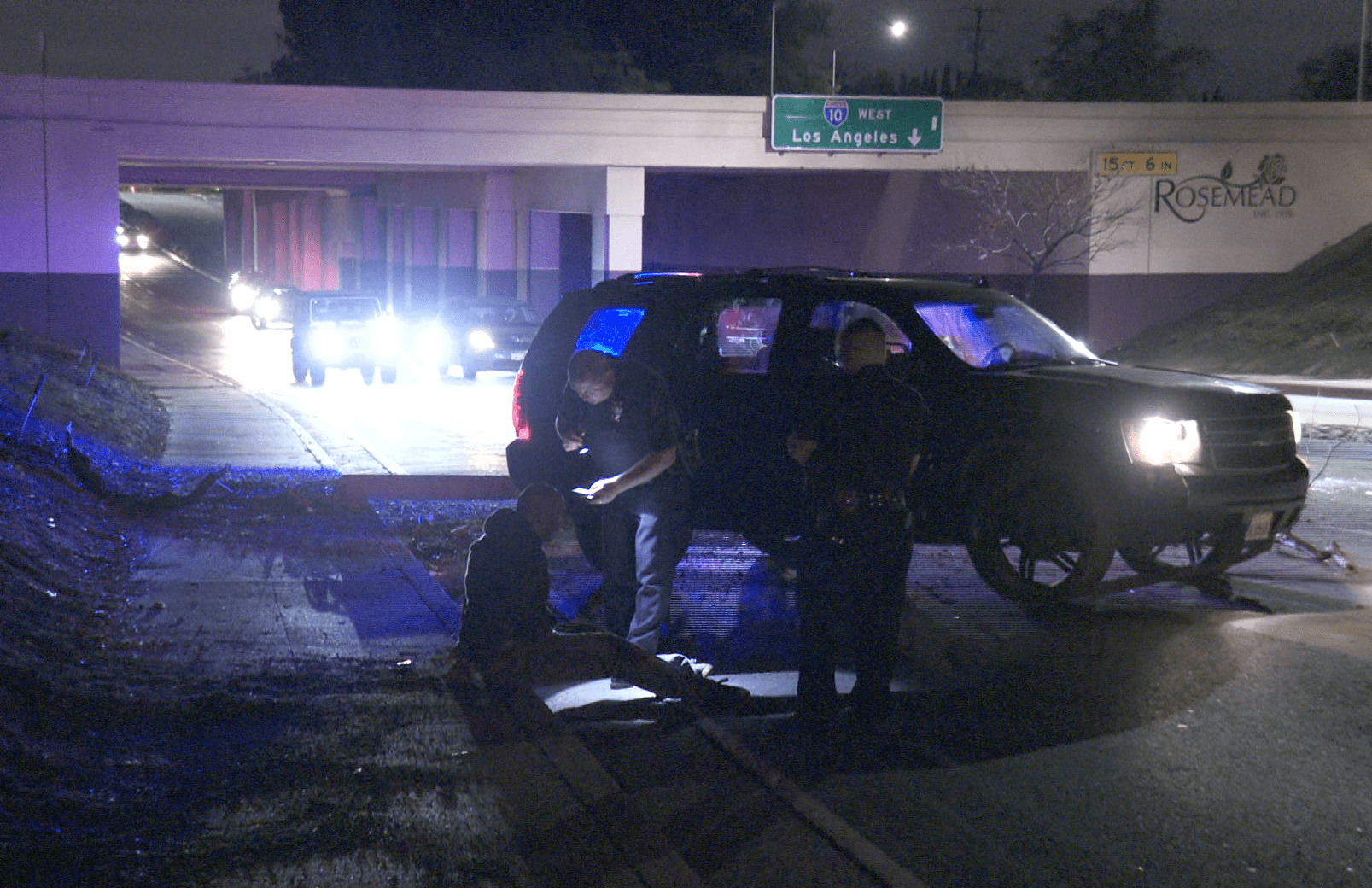 San Gabriel police detain a man near a damaged black Chevy Tahoe on April 17, 2019.