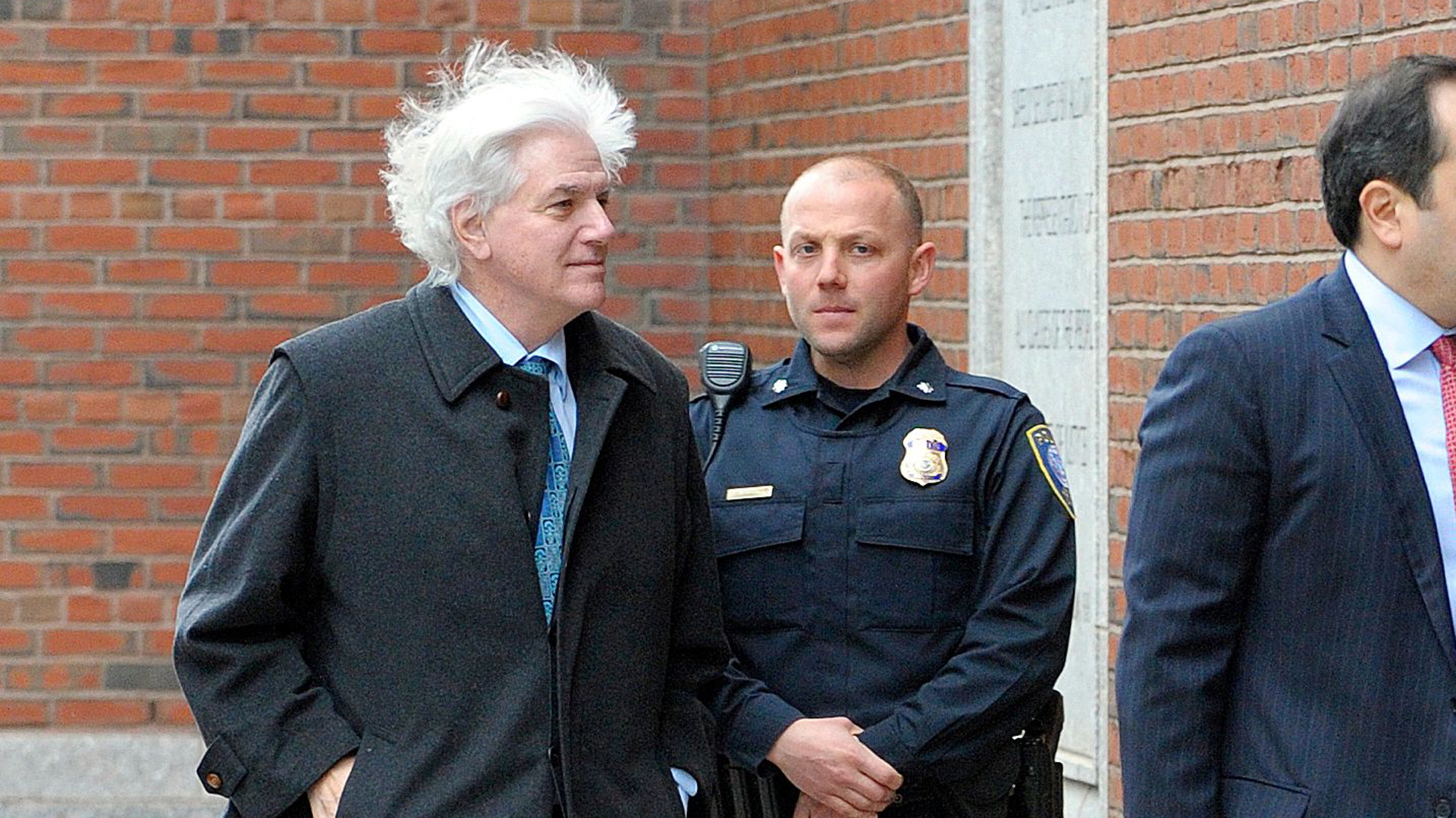 New York food and beverage distributor Gregory Abbott, left, makes his way to the John Joseph Moakley United States Courthouse to plea in front of a judge for charges in the college admissions scandal, on March 29, 2019, in Boston. (Credit: JOSEPH PREZIOSO/AFP/Getty Images)