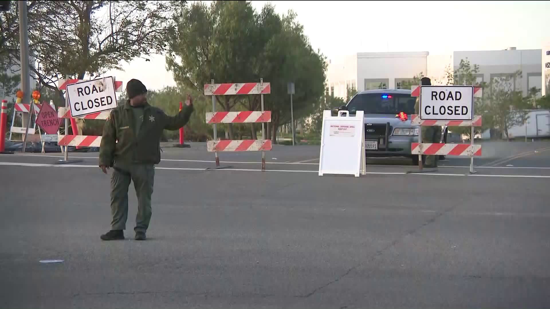 A man directs traffic on May 17, 2019, near March Air Reserve Base, in the area where an F-16 fighter jet crashed the previous day. (Credit: KTLA)