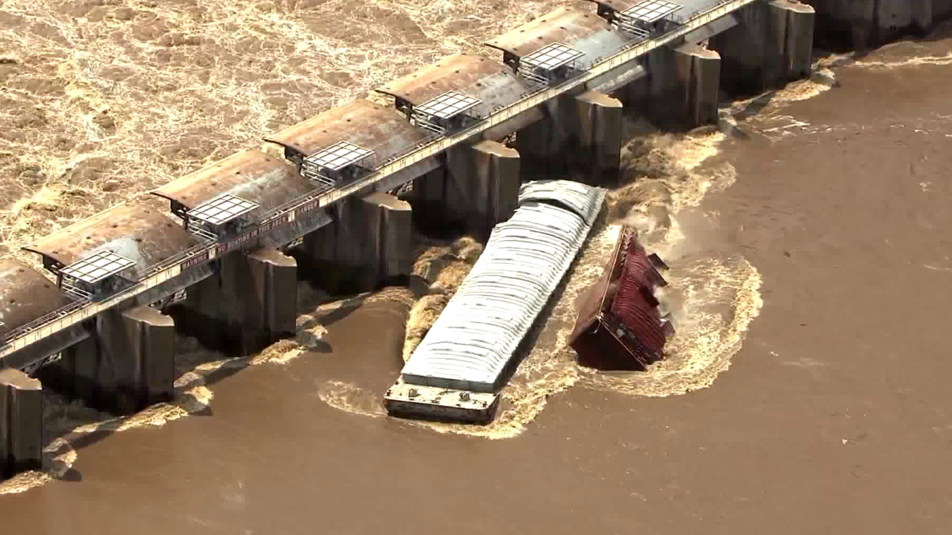 Two barges sank in the Arkansas River after crashing into the Webbers Falls Lock & Dam in Oklahoma on May 23, 2019. (Credit: KFOR)