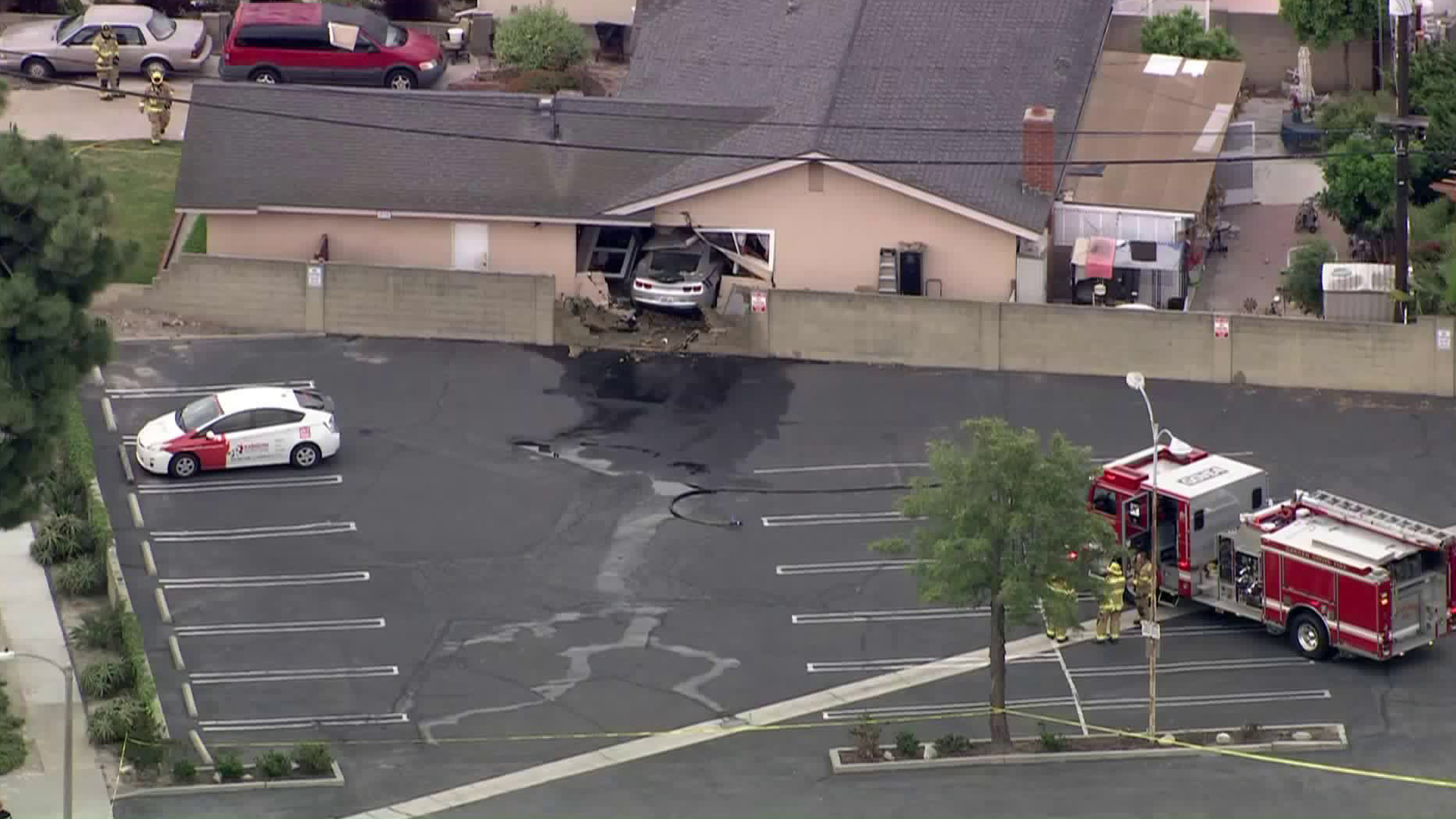 A vehicle is seen inside a Garden Grove home after the driver crashed through the fence and the wall on May 21, 2019. (Credit: Sky5)