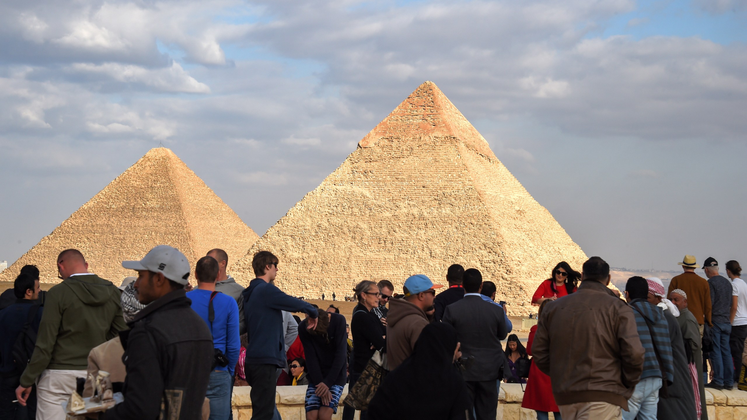 Tourists gather at the Giza pyramids necropolis in Egypt on Dec. 29, 2018, with the pyramids of Khafre and Khufu seen in the background. (Credit: MOHAMED EL-SHAHED/AFP/Getty Images)