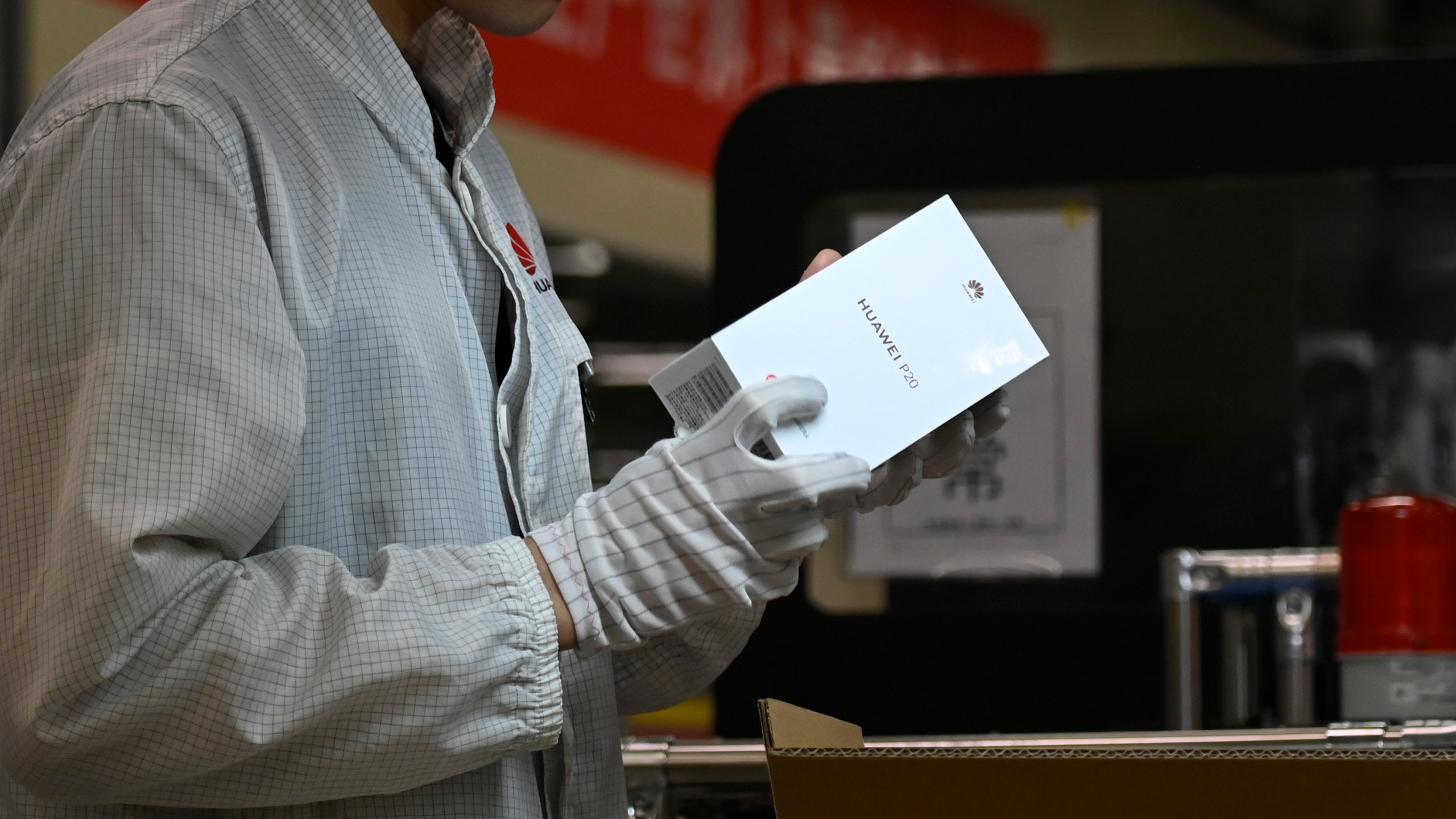 An employee works on a mobile phone production line at a Huawei production base during a media tour in Dongguan, China's Guangdong province on March 6, 2019. (Credit: WANG ZHAO/AFP/Getty Images)