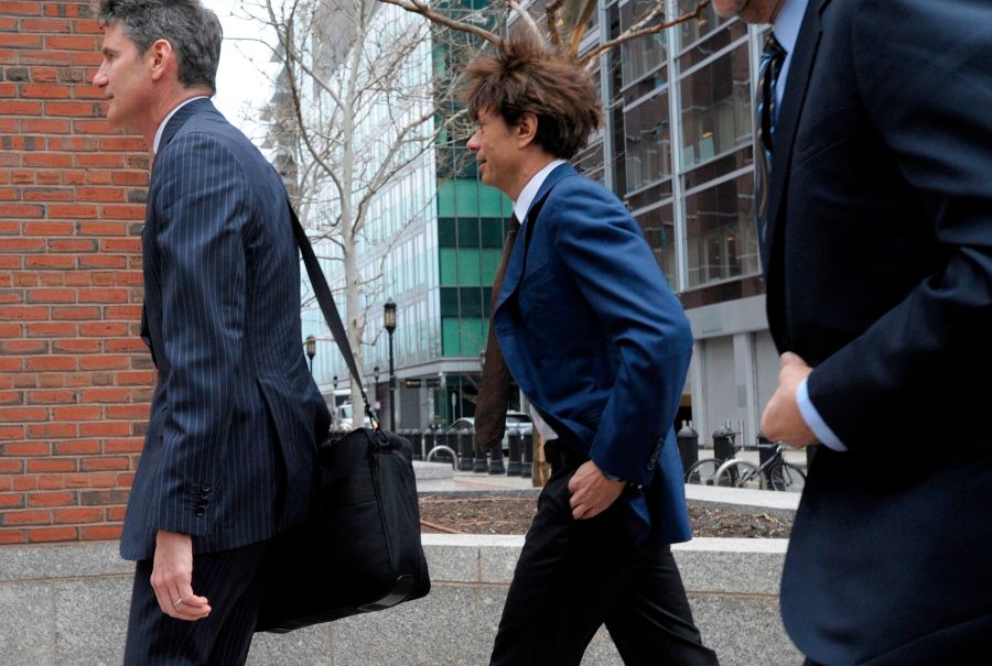 Napa Valley vintner Agustin Huneeus Jr., center, makes his way to the John Joseph Moakley U.S. Courthouse on March 29, 2019 in Boston. (Credit: JOSEPH PREZIOSO/AFP/Getty Images)