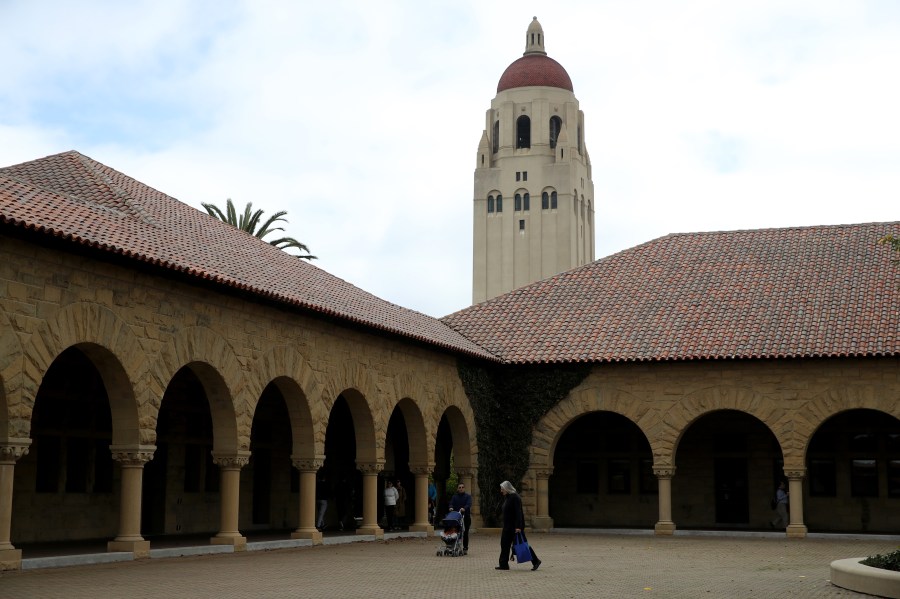 People walk by Hoover Tower on the Stanford University campus on March 12, 2019. (Credit: Justin Sullivan / Getty Images)