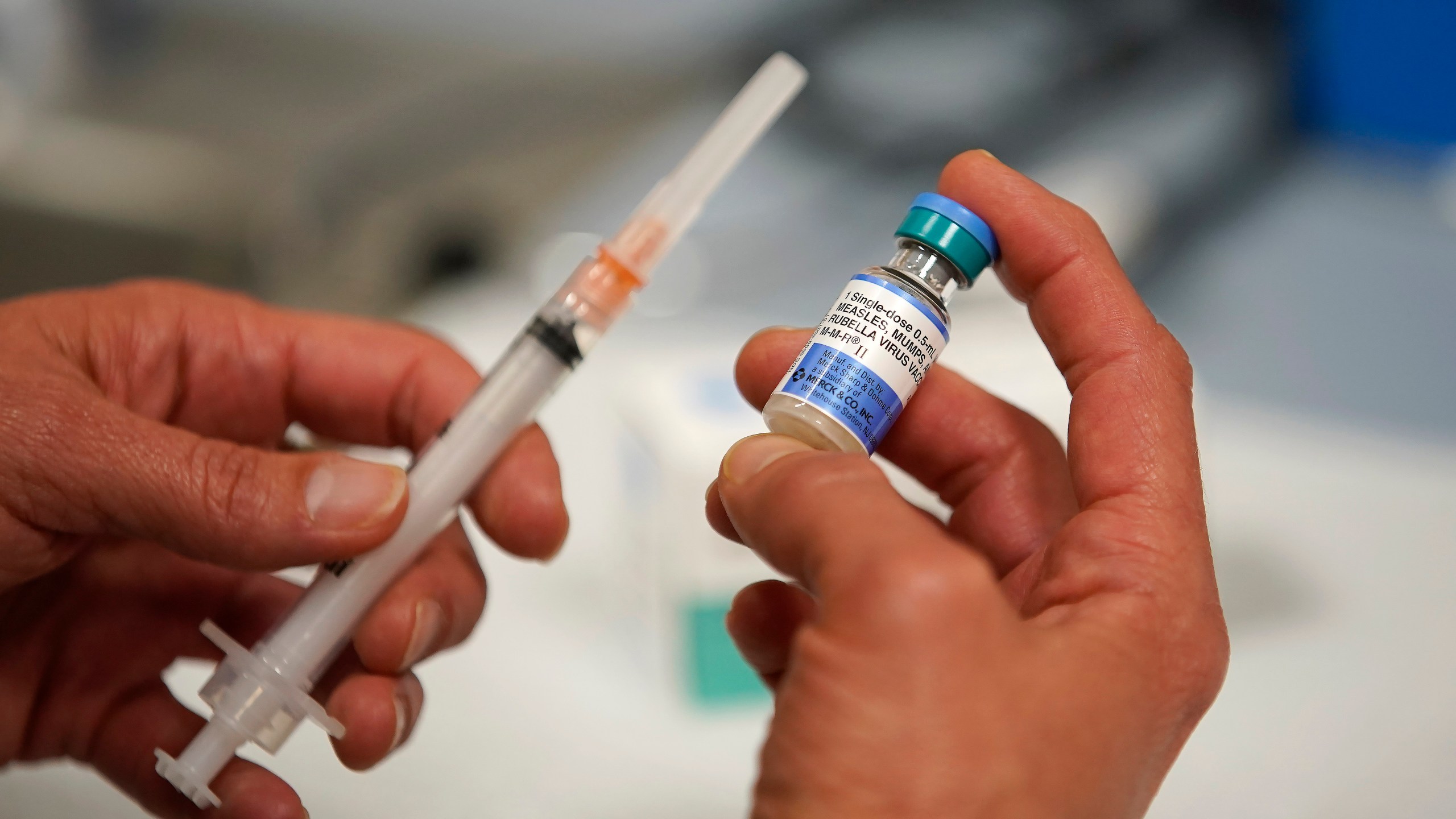 In this photo illustration a one dose bottle of measles, mumps and rubella virus vaccine, made by MERCK, is held up at the Salt Lake County Health Department on April 26, 2019 in Salt Lake City, Utah. (Credit: George Frey/Getty Images)