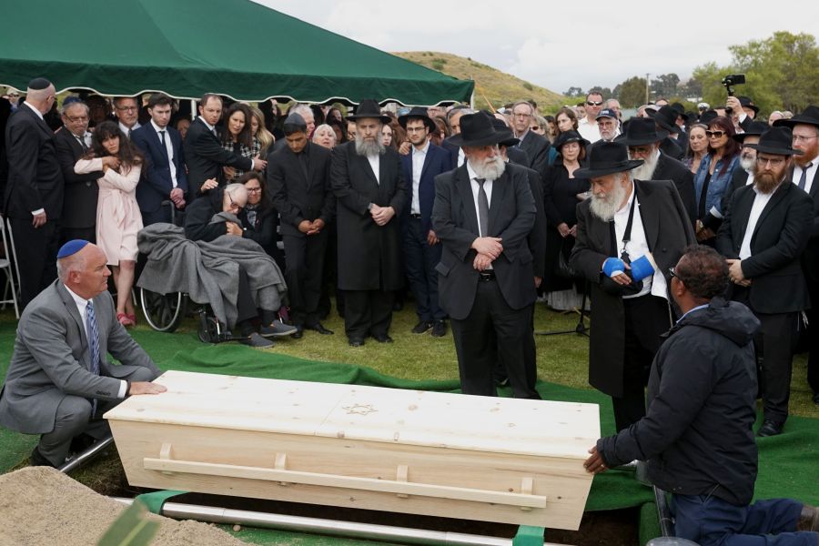 Mourners look over a coffin during the burial service for Lori Gilbert Kaye, who was killed in the Chabad of Poway Synagogue shooting, at El Camino cemetery in San Diego on April 29, 2019. (Credit: SANDY HUFFAKER/AFP/Getty Images)