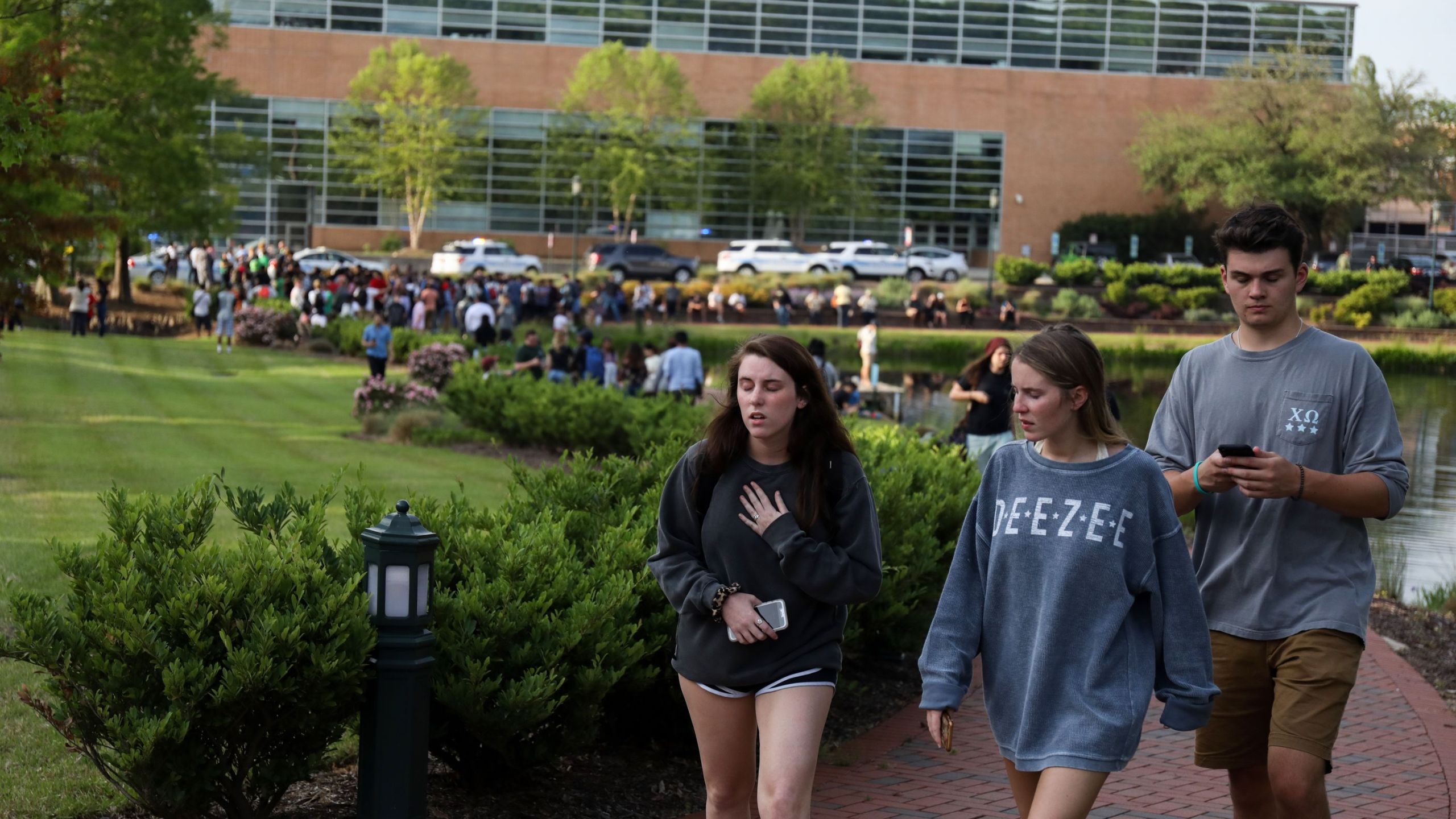 Students and faculty file out of buildings during a lockdown after a shooting on the campus of University of North Carolina Charlotte. (Credit: LOGAN CYRUS/AFP/Getty Images)