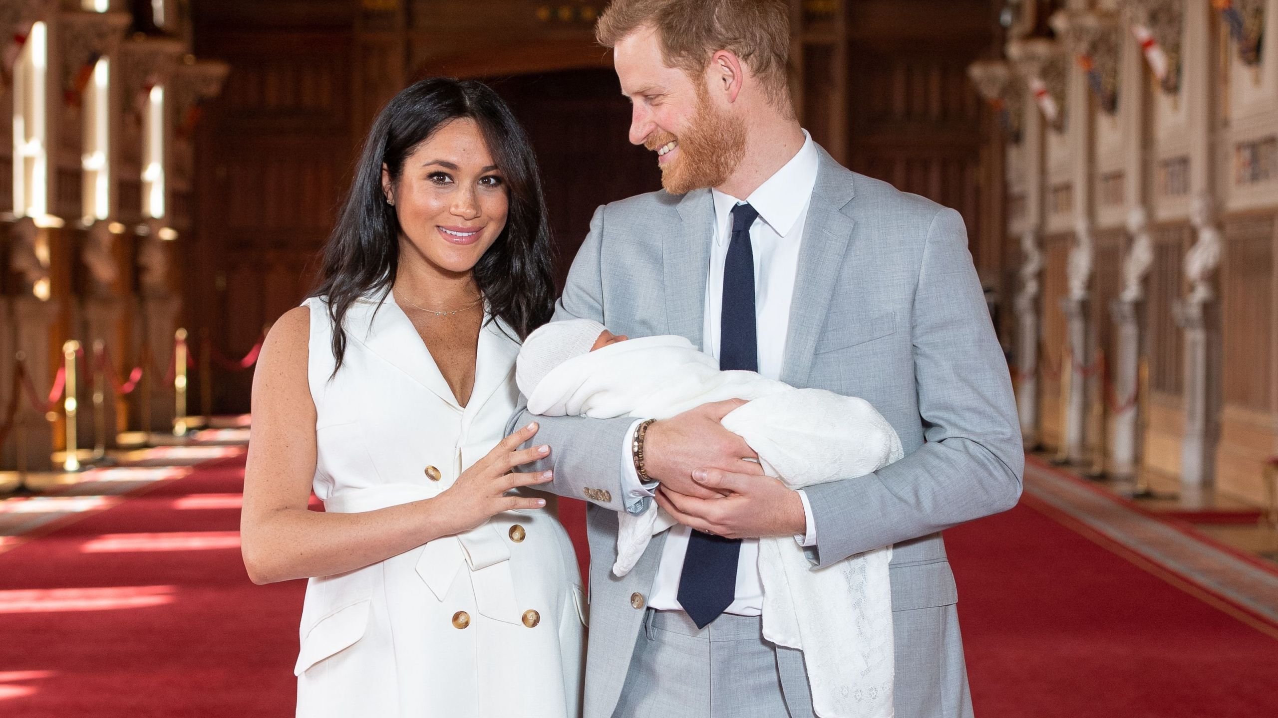 Britain's Prince Harry, Duke of Sussex (R), and his wife Meghan, Duchess of Sussex, pose for a photo with their newborn baby son in St George's Hall at Windsor Castle in Windsor, west of London on May 8, 2019. (Credit: DOMINIC LIPINSKI/AFP/Getty Images)