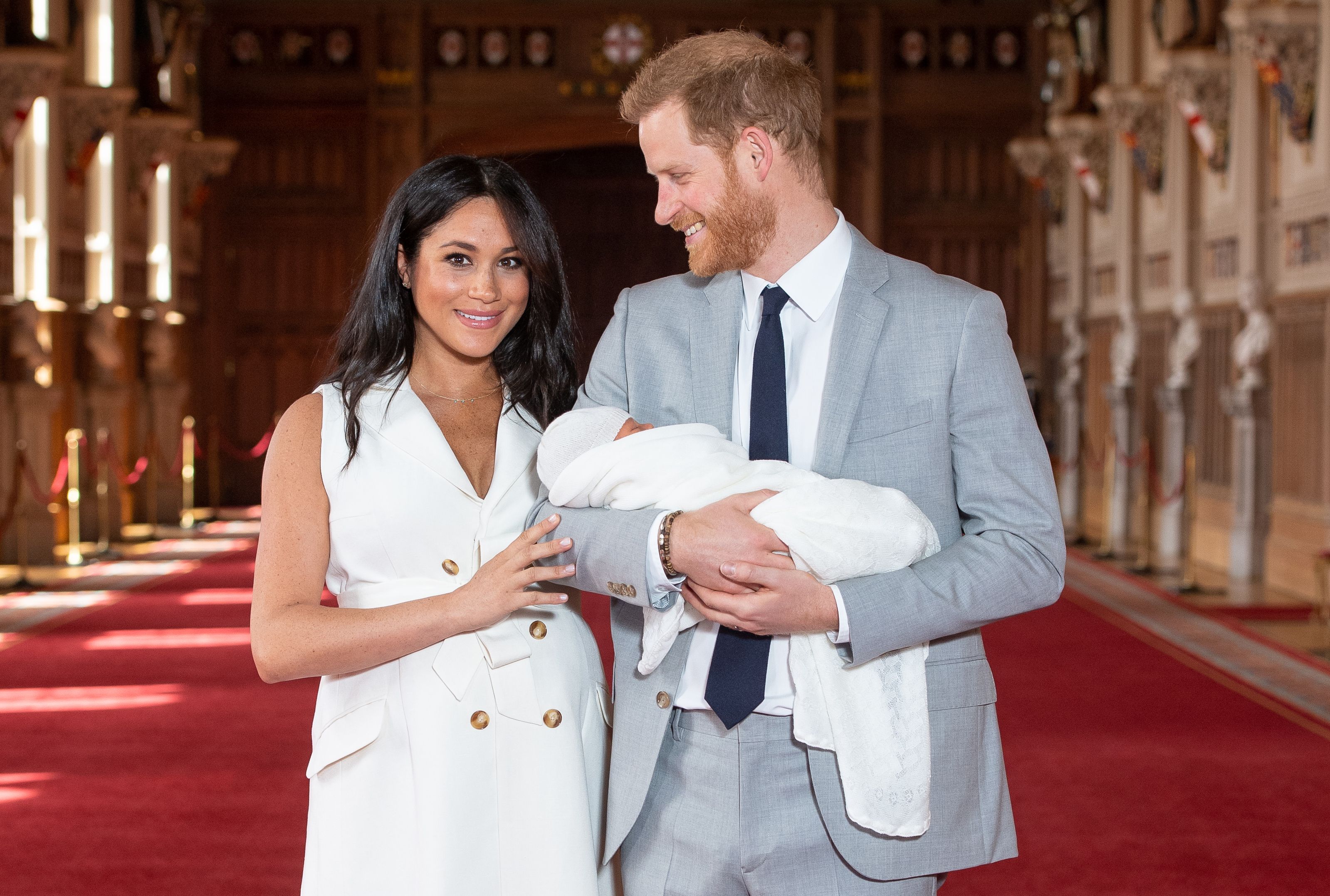 Britain's Prince Harry, Duke of Sussex (R), and his wife Meghan, Duchess of Sussex, pose for a photo with their newborn baby son in St George's Hall at Windsor Castle in Windsor, west of London on May 8, 2019. (Credit: DOMINIC LIPINSKI/AFP/Getty Images)