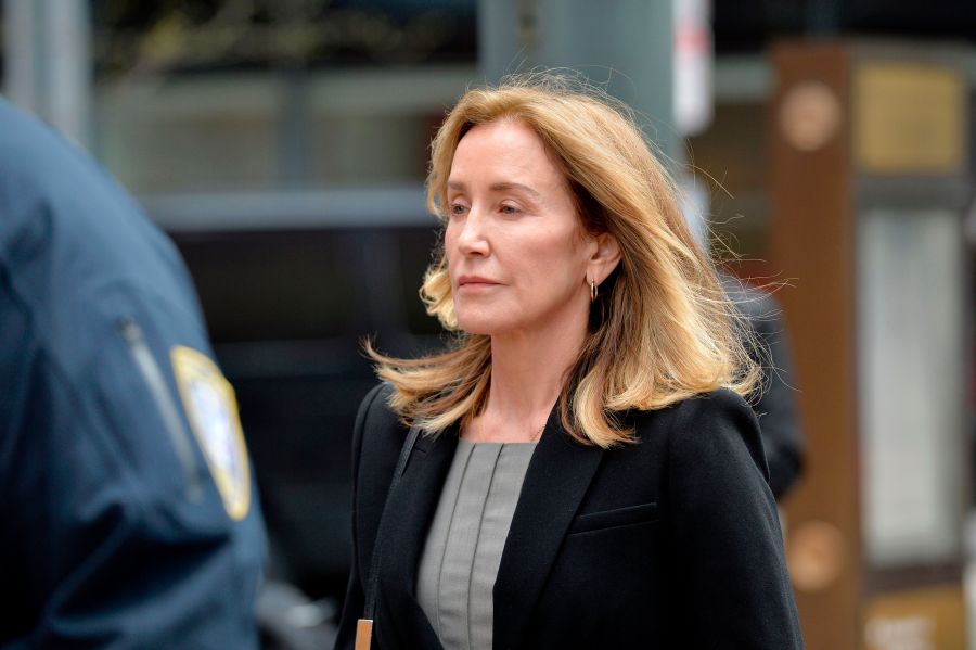 Actress Felicity Huffman is escorted by police into court where she pleaded guilty to one count of conspiracy to commit mail fraud and honest services mail fraud in the college admissions scandal in Boston on May 13, 2019. (Credit: JOSEPH PREZIOSO/AFP/Getty Images)