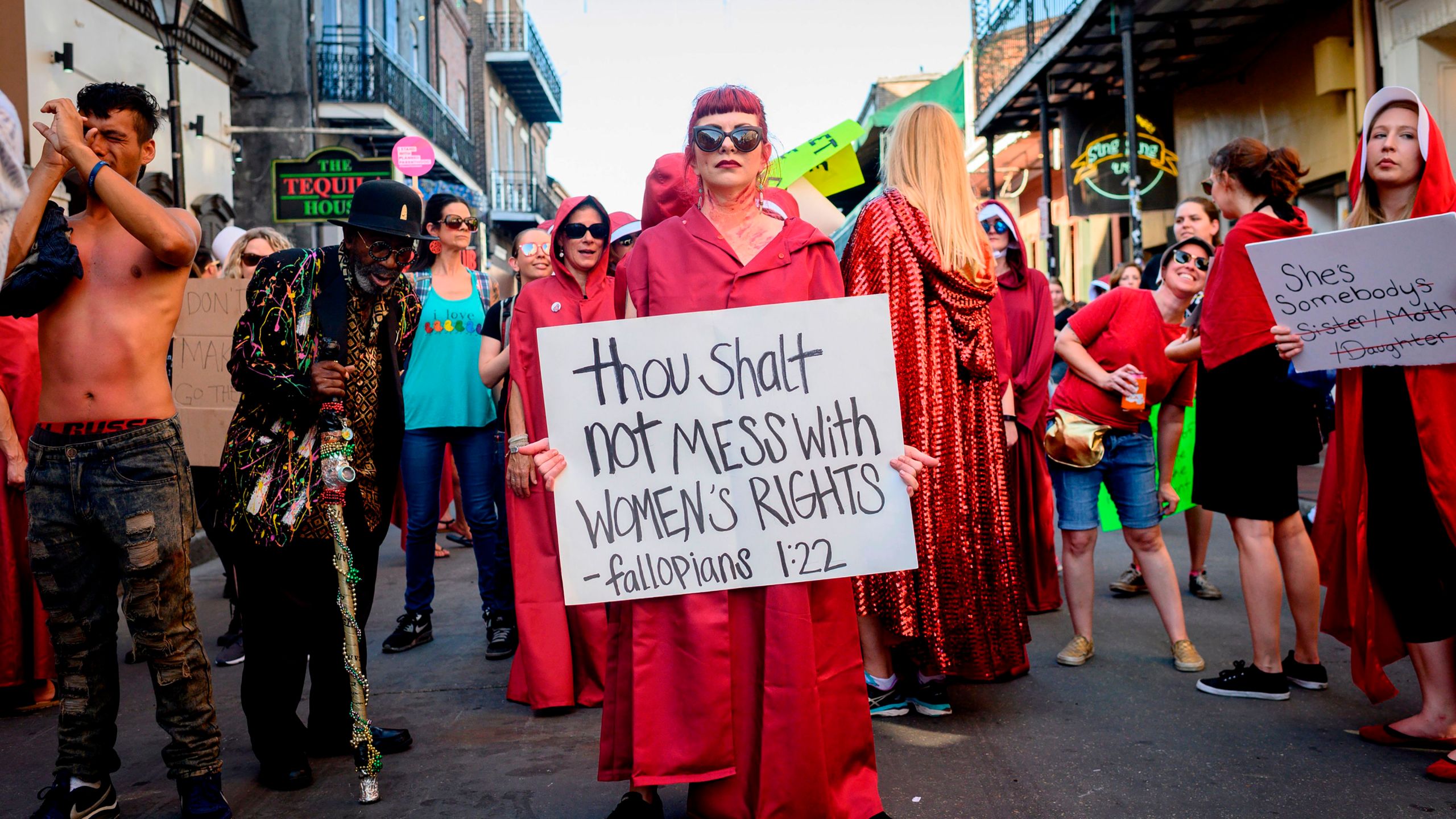 Handmaids-themed protesters march down Bourbon Street in the French Quarter of New Orleans on May 25, 2019. (Credit: EMILY KASK/AFP/Getty Images)