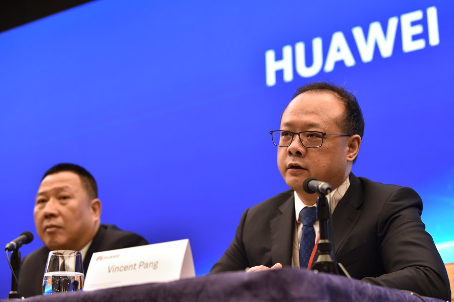 Song Liuping (L), chief legal officer of Chinese tech giant Huawei, and Vincent Pang (R), Head of Corporate Communications of Chinese tech giant Huawei, attend a press conference at the Huawei facilities in Shenzhen, Guangdong province on May 29, 2019. (Credit: HECTOR RETAMAL/AFP/Getty Images)