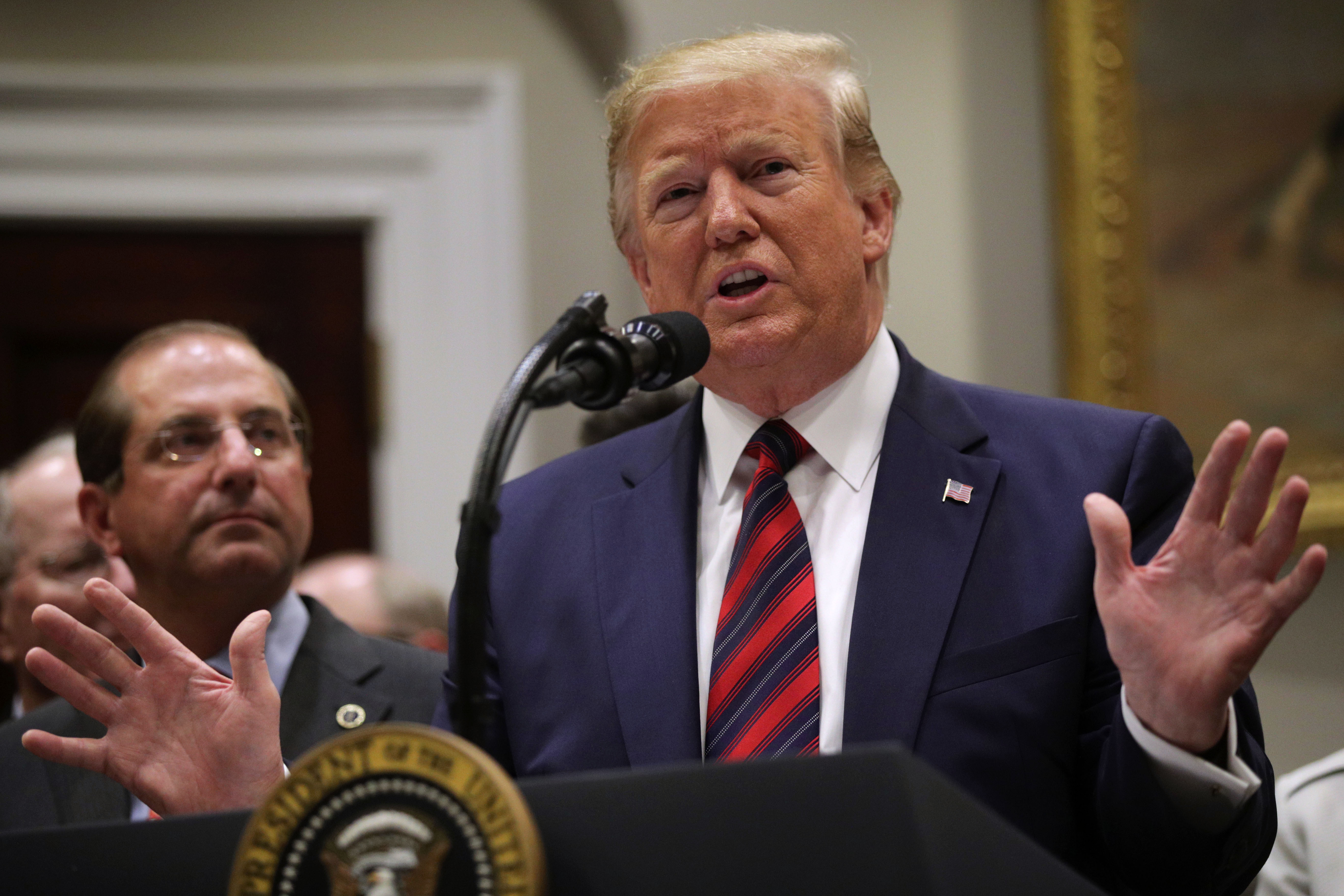 U.S. President Donald Trump speaks as Secretary of Health and Human Services Alex Azar listens during a Roosevelt Room event at the White House May 9, 2019 in Washington, DC. (Credit: Alex Wong/Getty Images)