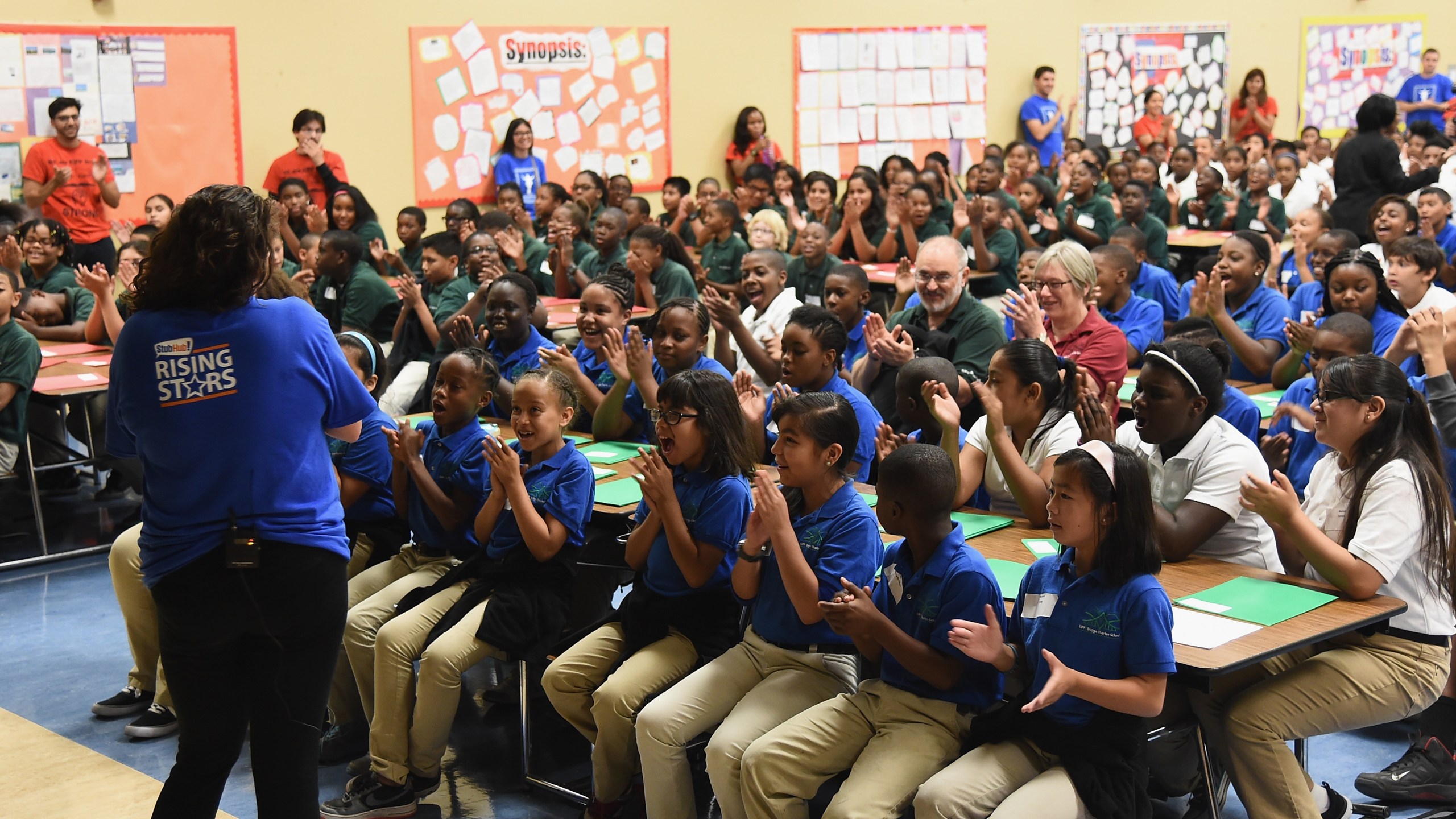 Music teacher Elizabeth Berliant talks with students as StubHub and Mr. Holland's Opus Surprise Bay Area Students with new instruments at KIPP Bridge Charter School on Aug. 12, 2014, in San Francisco. (Credit: Michael Buckner/Getty Images for StubHub)