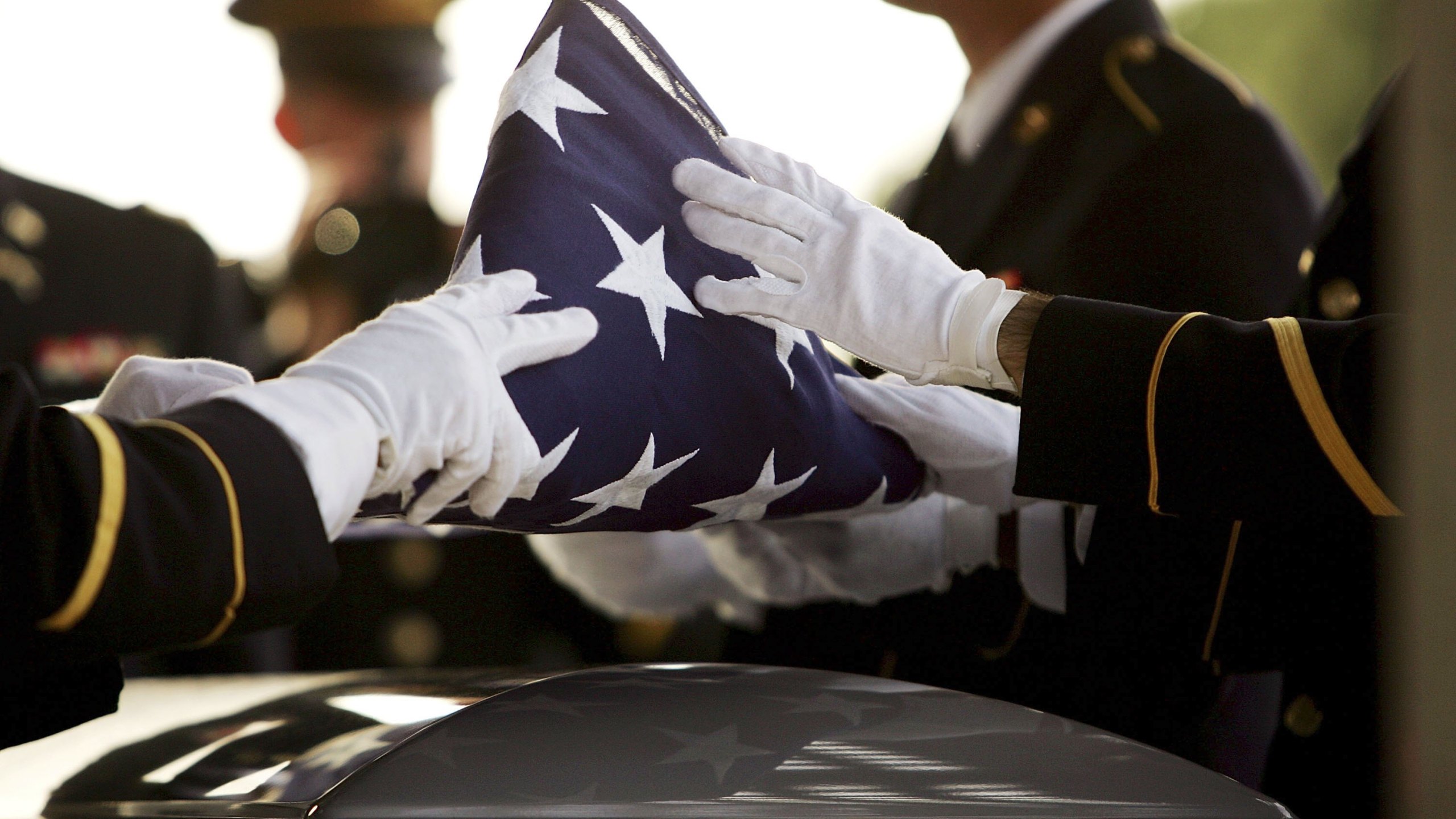 The flag covering the casket of California National Guard Sgt 1st Class Rudy A. Salcido is folded for presentation to his widow during a memorial service for him at the Riverside National Cemetery on Nov. 21, 2006, in Riverside. Staff Sgt. Vincent J. Rogers, who died in World War II when his bomber crash in the Pacific, will be remembered at the cemetery in May 2019. (Credit: David McNew/Getty Images)