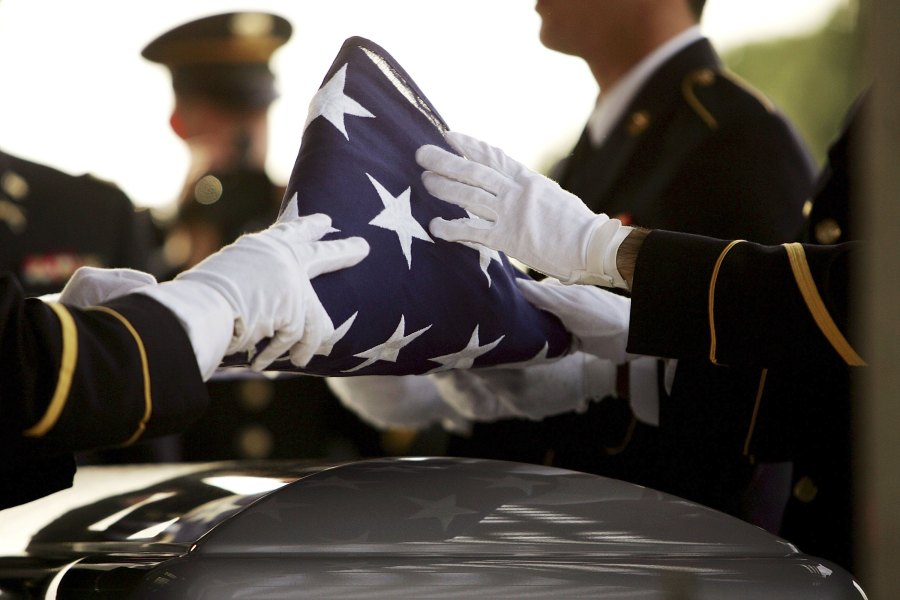 The flag covering the casket of California National Guard Sgt 1st Class Rudy A. Salcido is folded for presentation to his widow during a memorial service for him at the Riverside National Cemetery on Nov. 21, 2006, in Riverside. Staff Sgt. Vincent J. Rogers, who died in World War II when his bomber crash in the Pacific, will be remembered at the cemetery in May 2019. (Credit: David McNew/Getty Images)