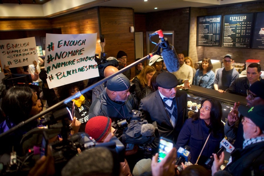 Starbucks Mid-Atlantic Regional Vice President Camille Hymes, center, addresses media and protestors in the Center City Starbucks in Philadelphia on April 15, 2018, after police arrested two black men who were waiting inside the location. (Credit: Mark Makela / Getty Images)