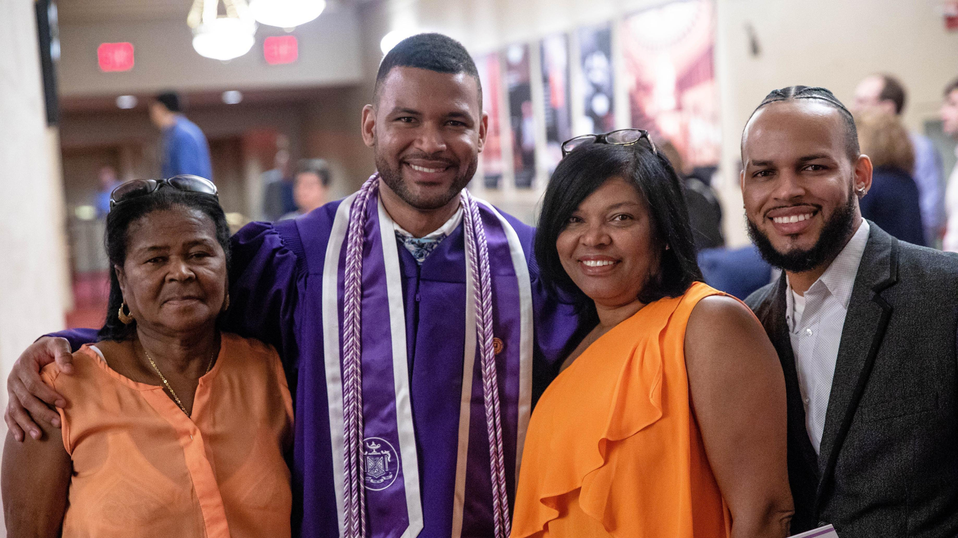 Frank Baez celebrates with his family after graduating Monday from New York University Rory Meyers College of Nursing. He posed with his grandmother Tomasina De los Santos, left, his mom, Santa Marte, and his older brother Juan Baez. (Credit: New York University)