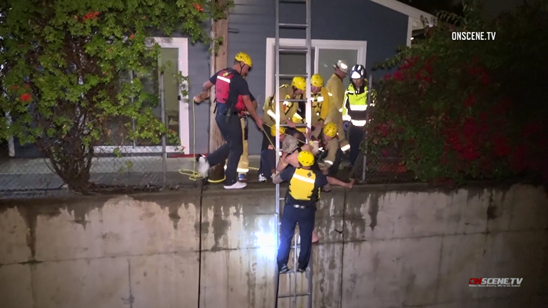 A man is rescued from the rushing waters of a drainage ditch in Fullerton on May 19, 2019. (Credit: OnScene.TV)