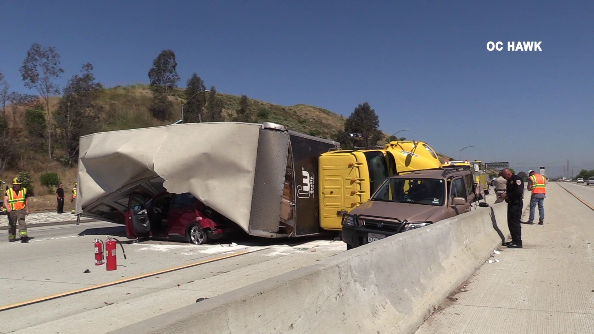 A box truck overturned, pinning a car beneath it, after being involved in a multivehicle crash in Chino Hills on June 12, 2019. (Credit: OC Hawk)