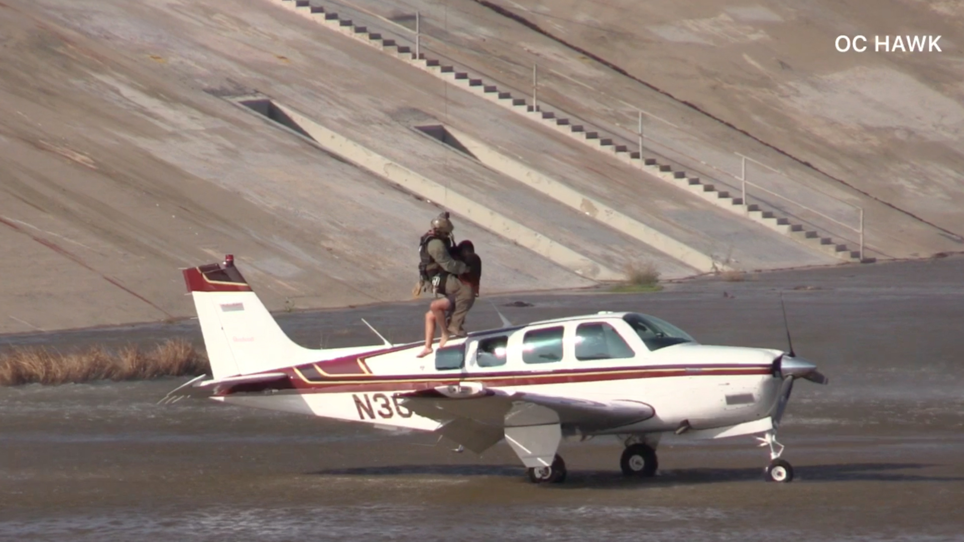 Rescuers hoist a pilot from a plane after an emergency landing in a wash near the san Gabriel Valley Regional Airport in El Monte on June 27, 2019. (Credit: OC Hawk)