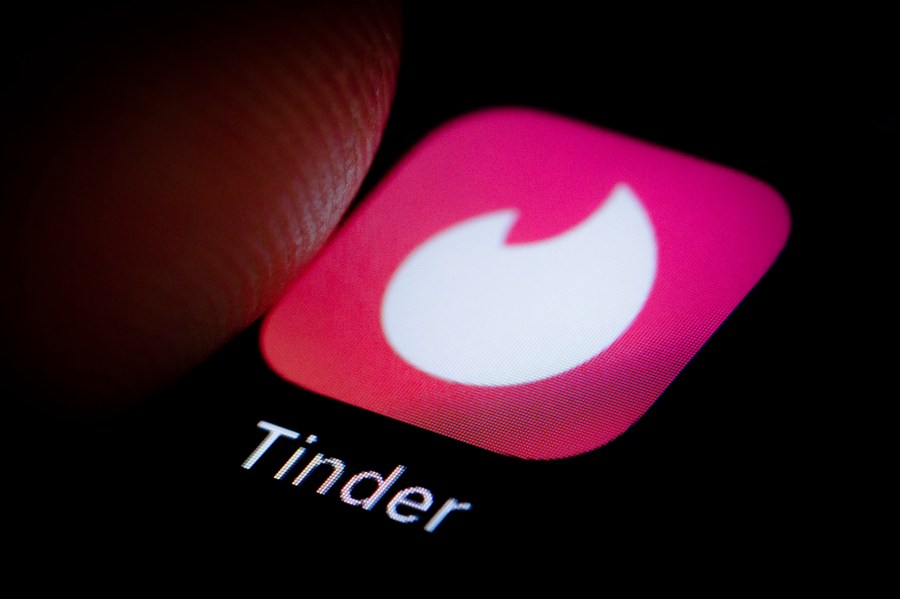 The Logo of location-based social search mobile app Tinder is displayed on a smartphone on October 05, 2018. (Credit: Thomas Trutschel/Photothek via Getty Images)