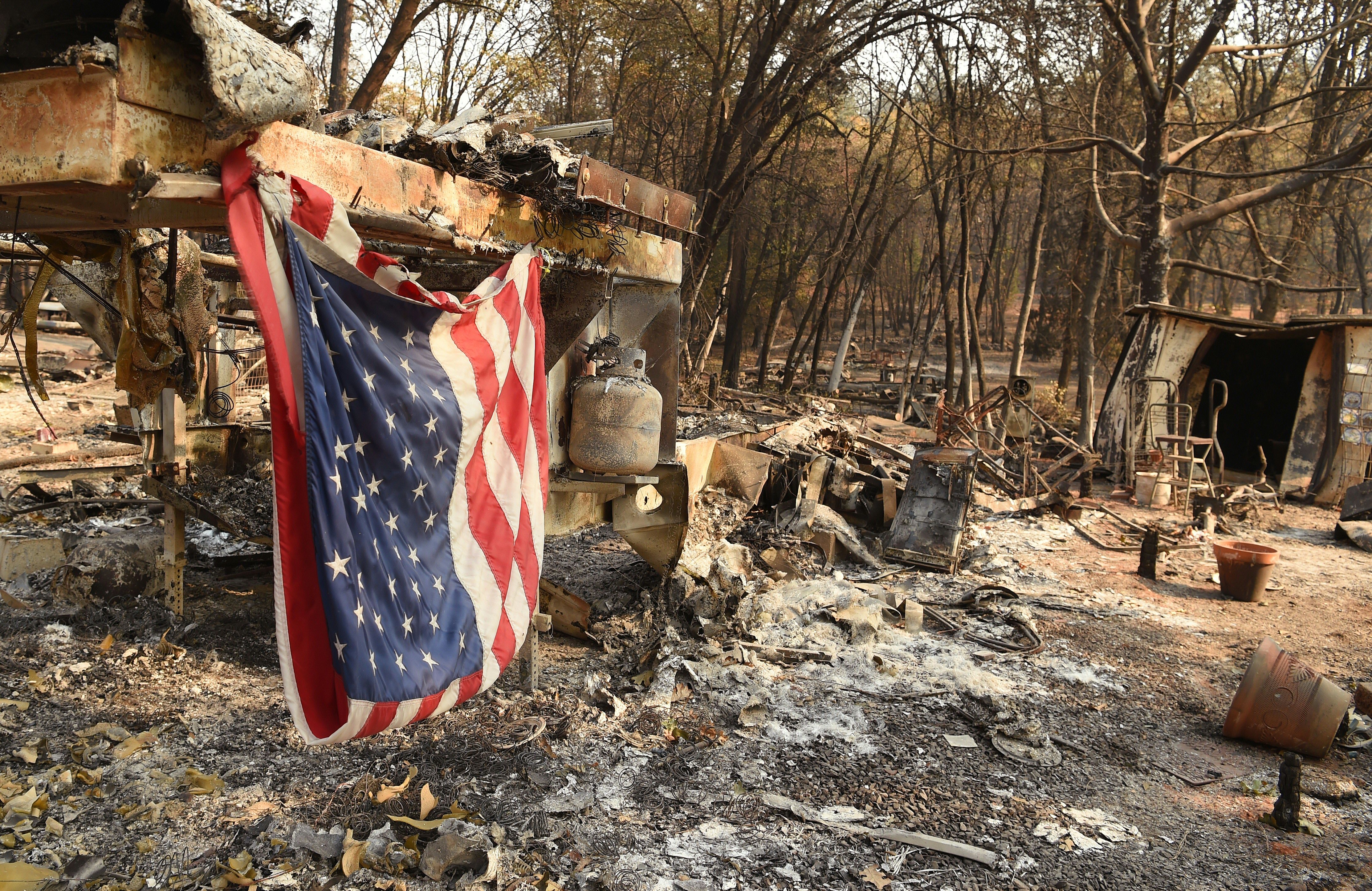 An American flag hangs at a burned out mobile home park in Paradise, California on Nov. 18, 2018. (JOSH EDELSON/AFP/Getty Images)