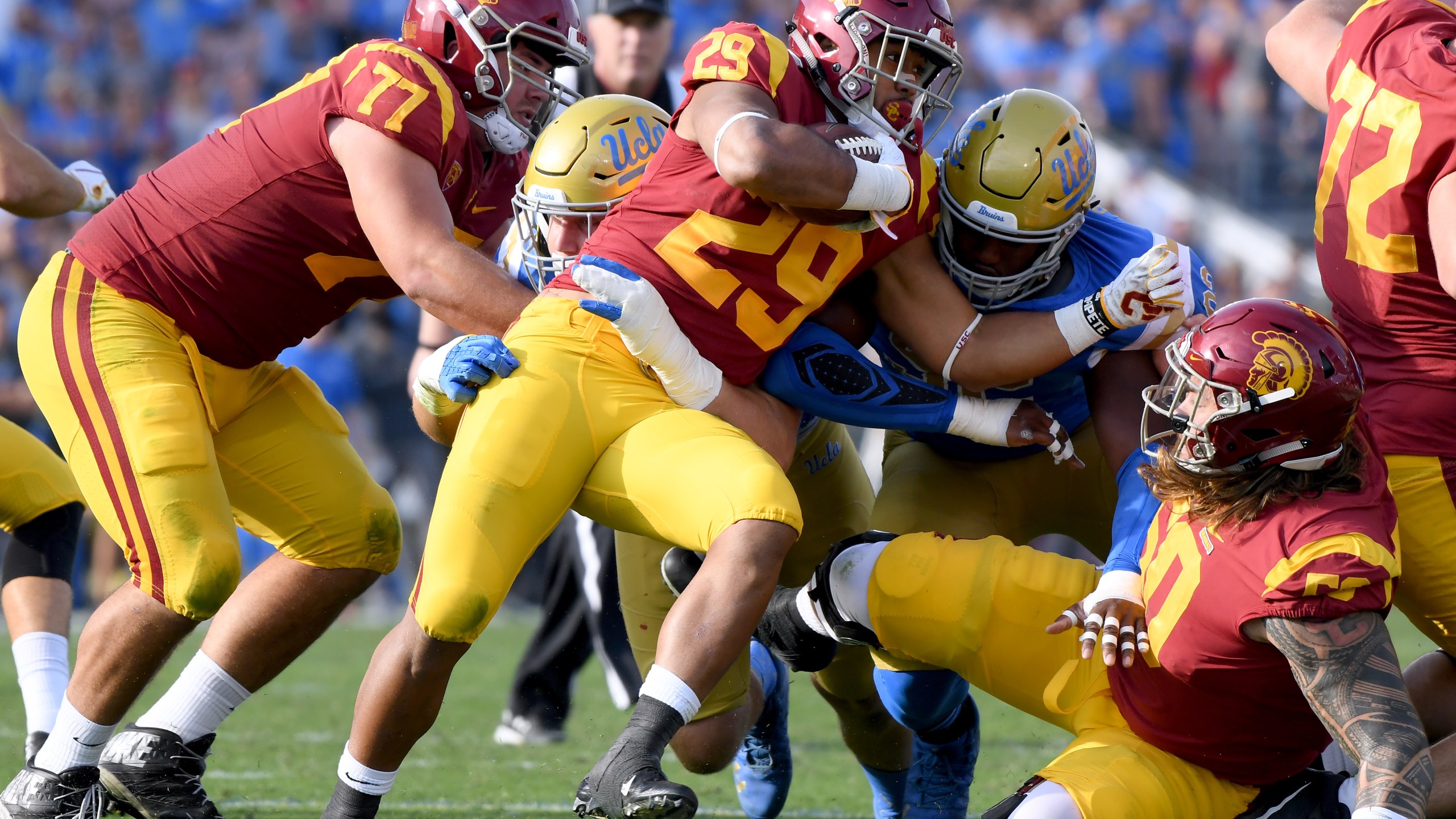 Players from the USC Trojans and the UCLA Bruins play football at the Rose Bowl on Nov. 17, 2018, in Pasadena. (Harry How/Getty Images)