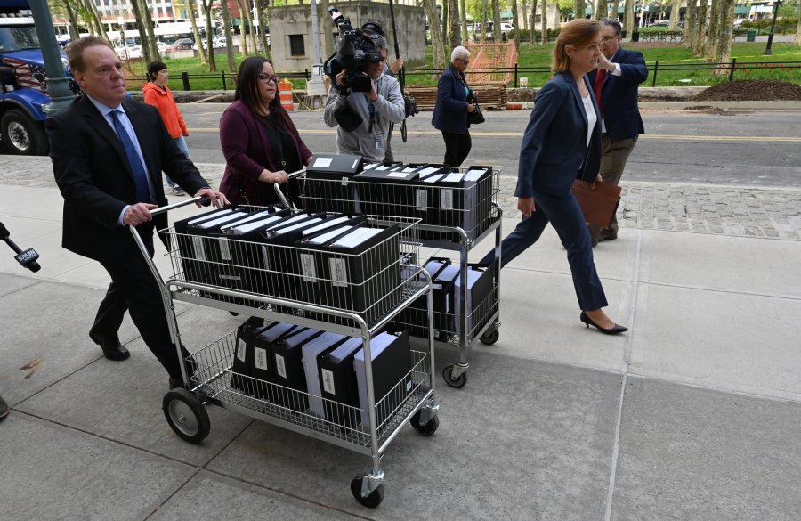 Members of the prosecution in the Nxivm case arrive with documents at Brooklyn Federal Court on May 7, 2019, for day one of the trial of Keith Raniere, founder of Nxivm. (Credit: TIMOTHY A. CLARY/AFP/Getty Images)