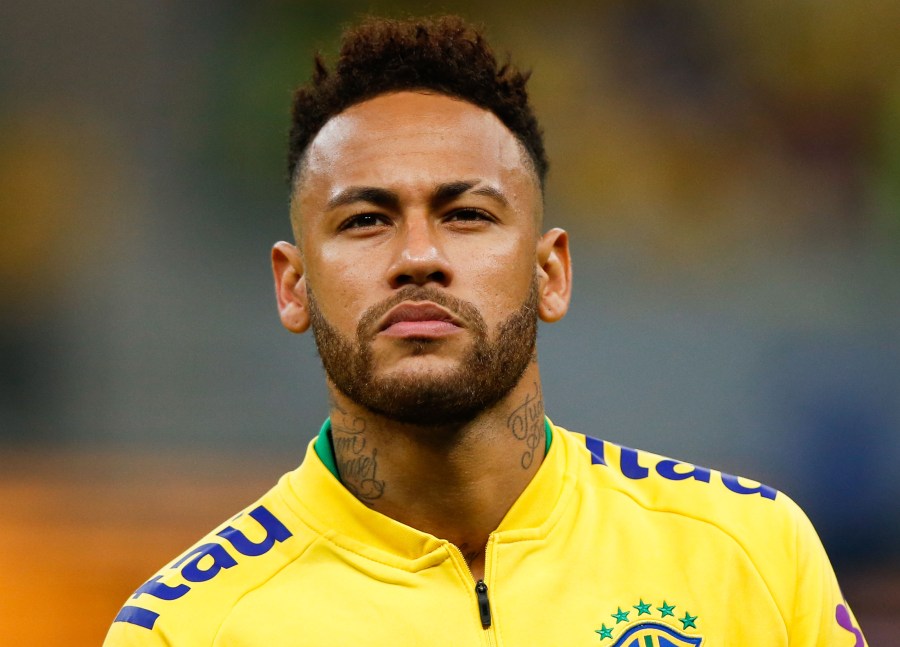 Neymar Jr. of Brazil looks on during the national anthem before the friendly match against Qatar at Mane Garrincha Stadium on June 5, 2019, in Brasilia, Brazil. (Credit: Alexandre Schneider/Getty Images)