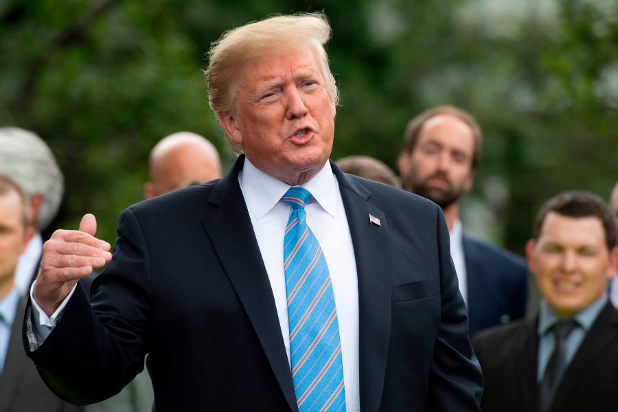 US President Donald Trump gives remarks after receiving a helmet from French race car driver and Indianapolis 500 winner Simon Pagenaud at the White House in Washington, DC, on June 10, 2019. (Credit: JIM WATSON/AFP/Getty Images)