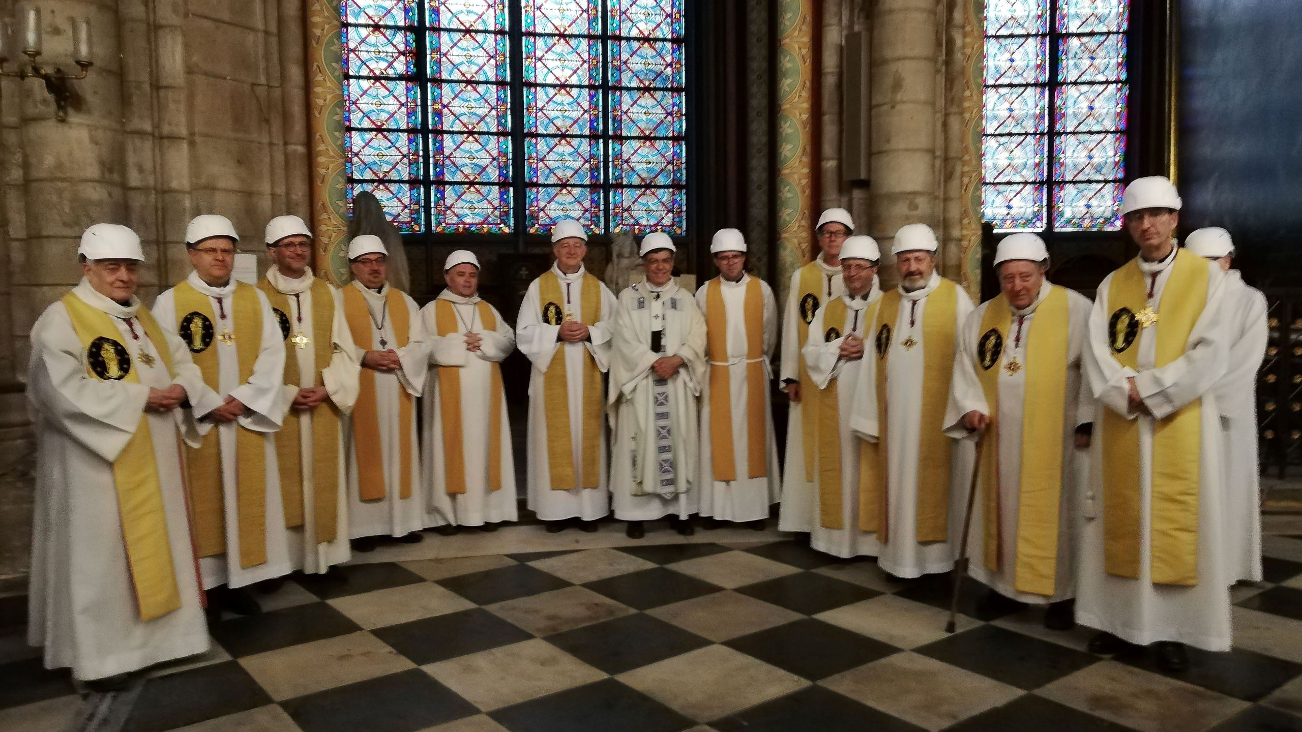 The Archbishop of Paris Michel Aupetit (C) poses with other members of the clergy following the first mass in a side chapel, two months to the day after a devastating fire engulfed the Notre-Dame de Paris cathedral, on June 15, 2019, in Paris.(Credit: KARINE PERRET/AFP/Getty Images)