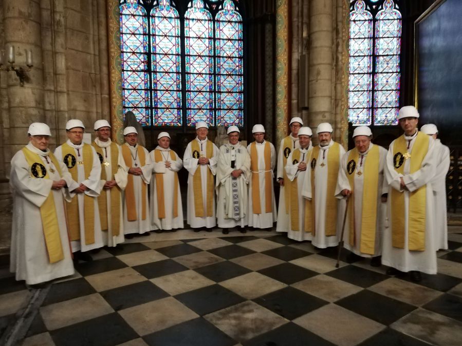 The Archbishop of Paris Michel Aupetit (C) poses with other members of the clergy following the first mass in a side chapel, two months to the day after a devastating fire engulfed the Notre-Dame de Paris cathedral, on June 15, 2019, in Paris.(Credit: KARINE PERRET/AFP/Getty Images)