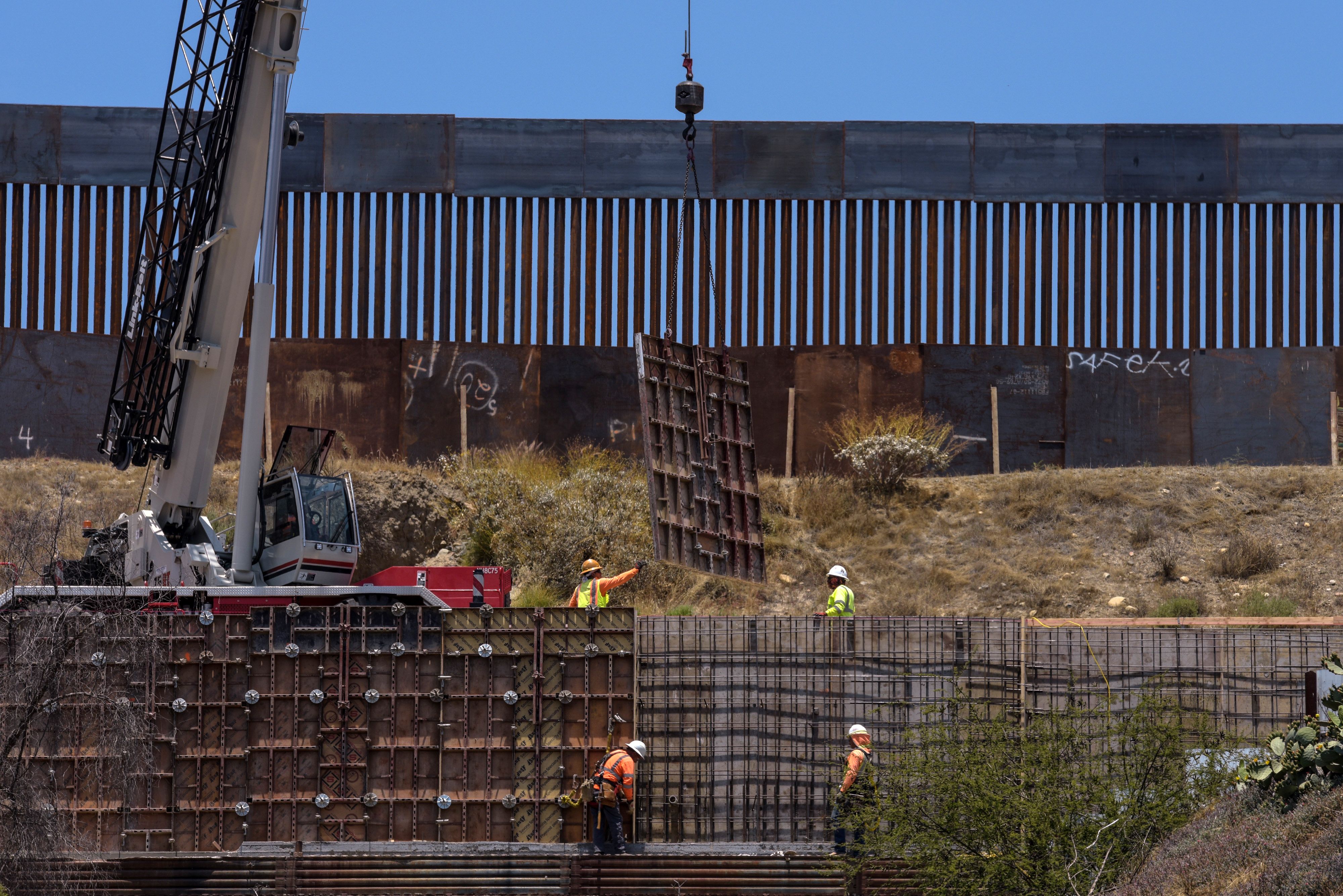 Workers set up a second layer of wall along the U.S.-Mexico border in Tijuana on June 18, 2019. (Credit: Agustin Paullier / AFP / Getty Images)