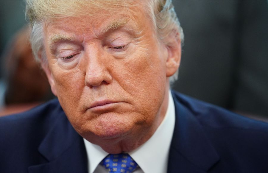 Donald Trump signs an executive order to establish a White House council on affordable housing in the Oval Office of the White House in Washington, DC on June 25, 2019. (Credit: MANDEL NGAN/AFP/Getty Images)