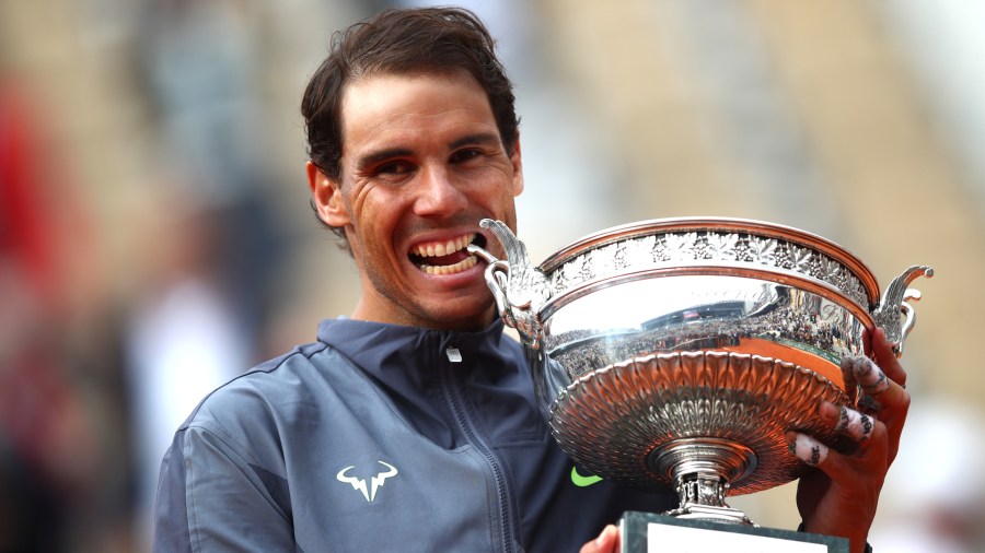 Rafael Nadal bites the winners trophy after his victory in day 15 of the 2019 French Open at Roland Garros on June 9, 2019, in Paris, France. (Credit: Julian Finney/Getty Images)