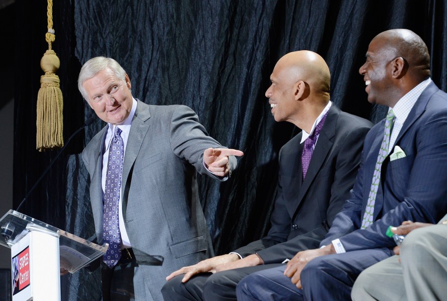 Jerry West, left, points to Kareem Abdul-Jabbar and Magic Johnson during a ceremony where Abdul-Jabbar unveiled a statue of himself at Staples Center on Nov. 16, 2012. (Credit: Kevork Djansezian/Getty Images)