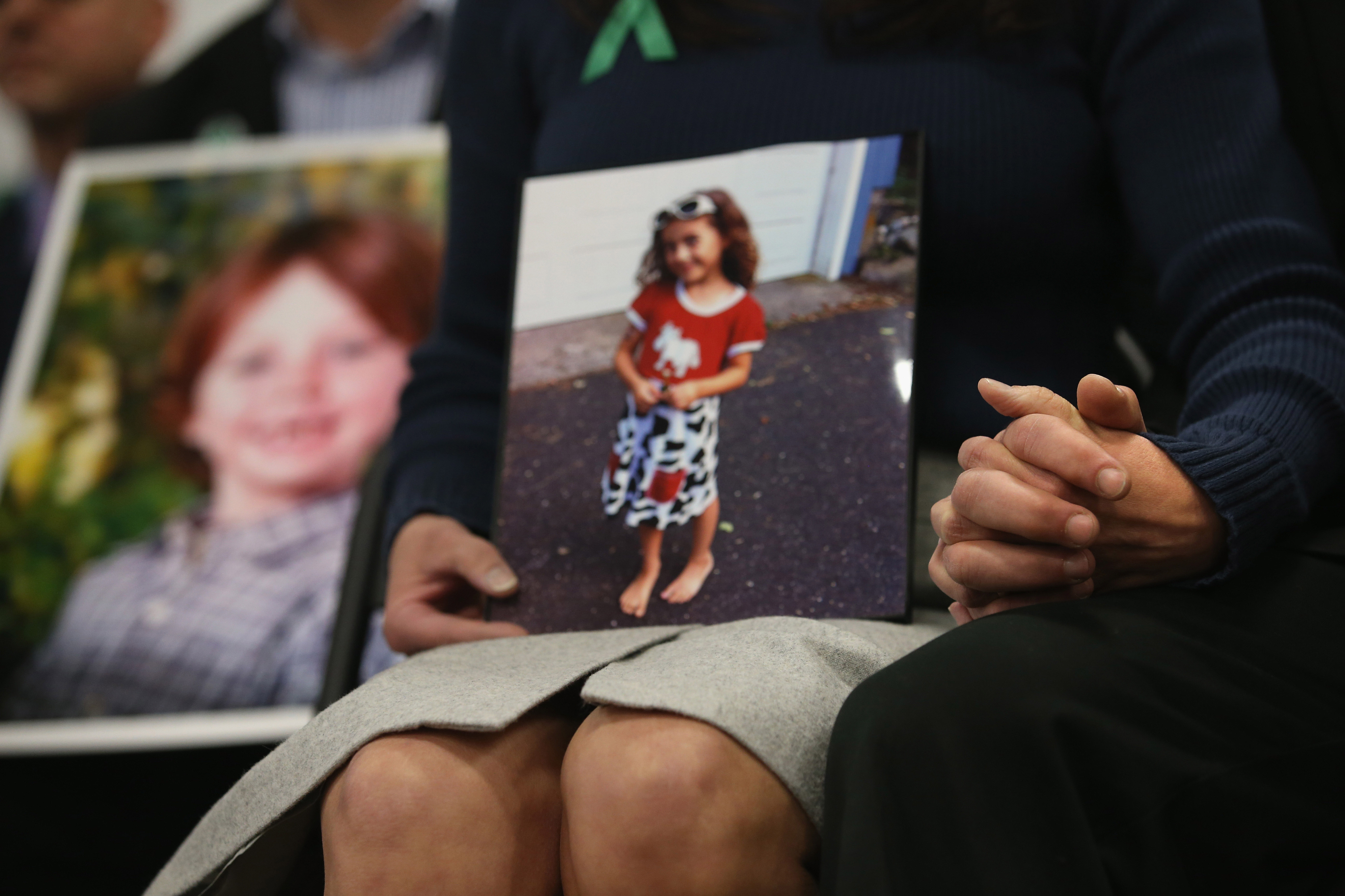 Parents of the Sandy Hook Elementary shooting victims hold hands on the one-month anniversary the massacre on Jan. 14, 2013 in Newtown, Connecticut. (Credit: John Moore/Getty Images)