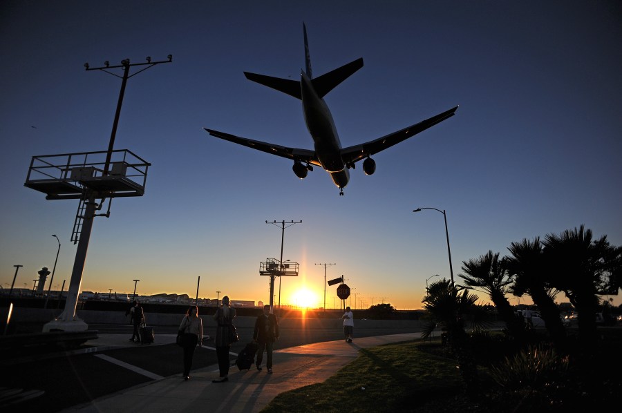 A plane lands at LAX airport. (Credit: ROBYN BECK/AFP/Getty Images)