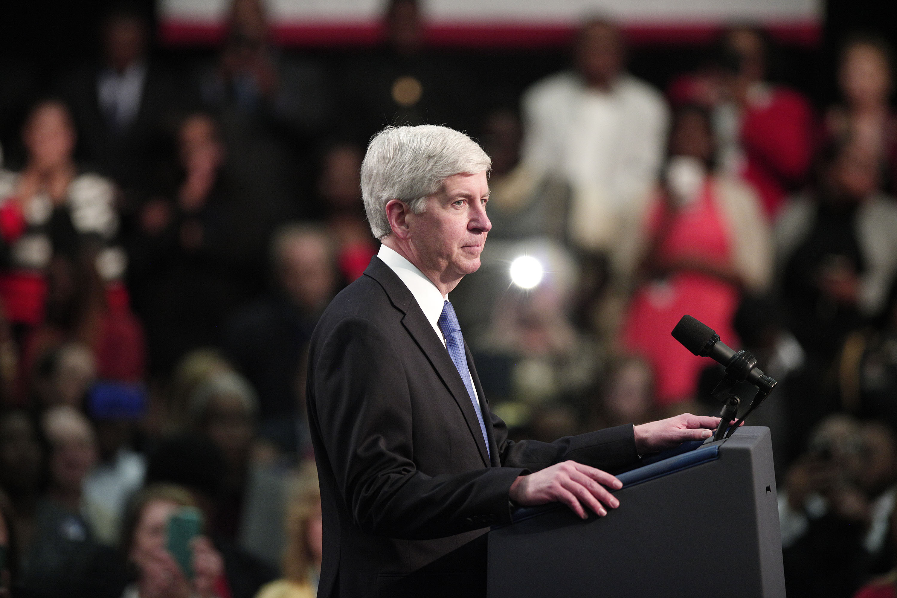 Rick Snyder listens from the stage as the crowd boos at a May 4, 2016 event addressing the water contamination in Flint, Michigan. (Credit: Bill Pugliano/Getty Images)