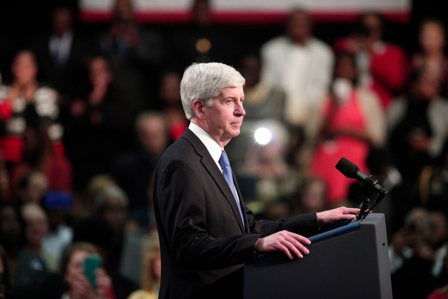 Rick Snyder listens from the stage as the crowd boos at a May 4, 2016 event addressing the water contamination in Flint, Michigan. (Credit: Bill Pugliano/Getty Images)