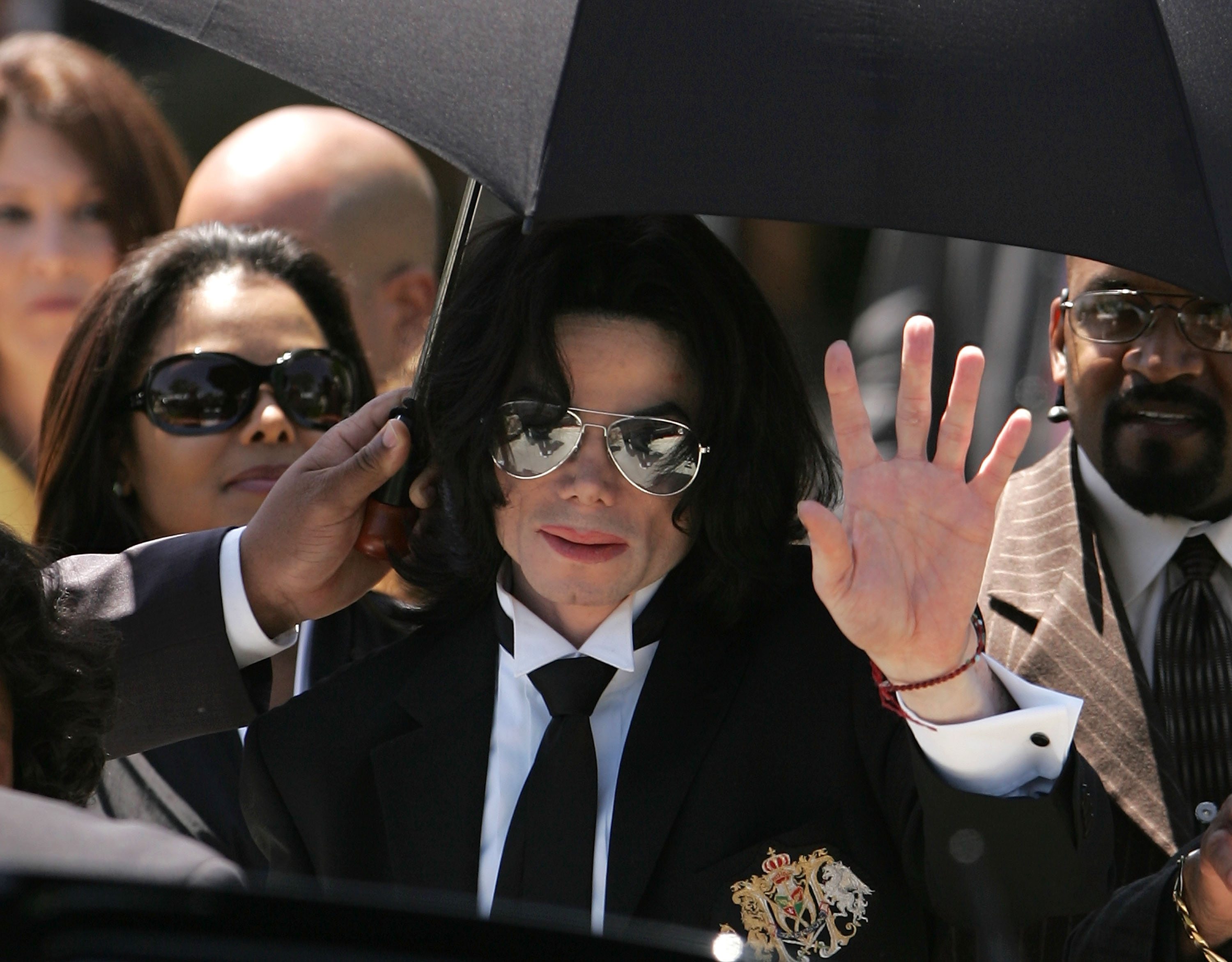 Michael Jackson waves to fans after he is found not guilty on all counts in his child molestation trial at the Santa Barbara County Courthouse June 13, 2005 in Santa Maria, California. (Credit: Win McNamee/Getty Images)