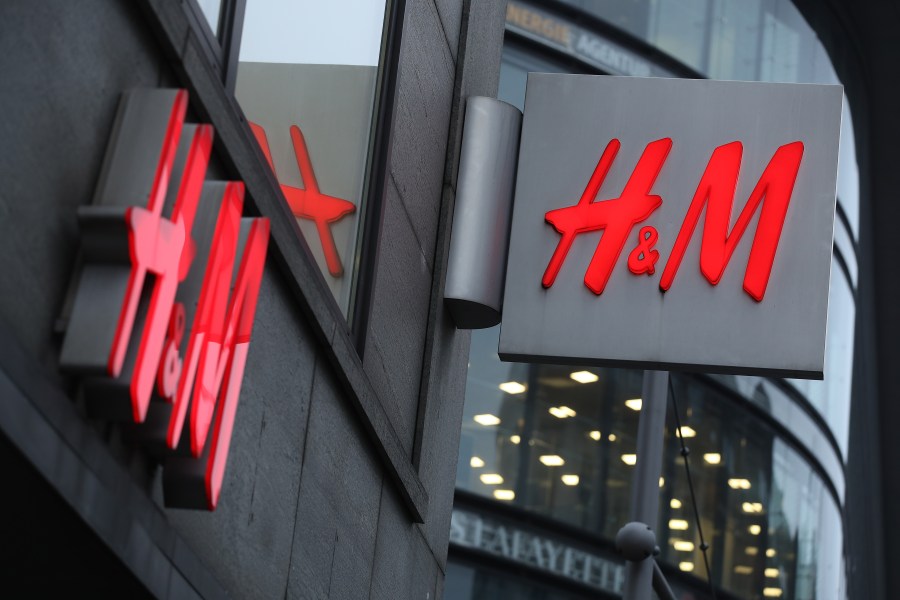 The logo of Swedish clothing retailer H&M hangs over one of its stores on March 28, 2018 in Berlin, Germany. (Credit: Sean Gallup/Getty Images)